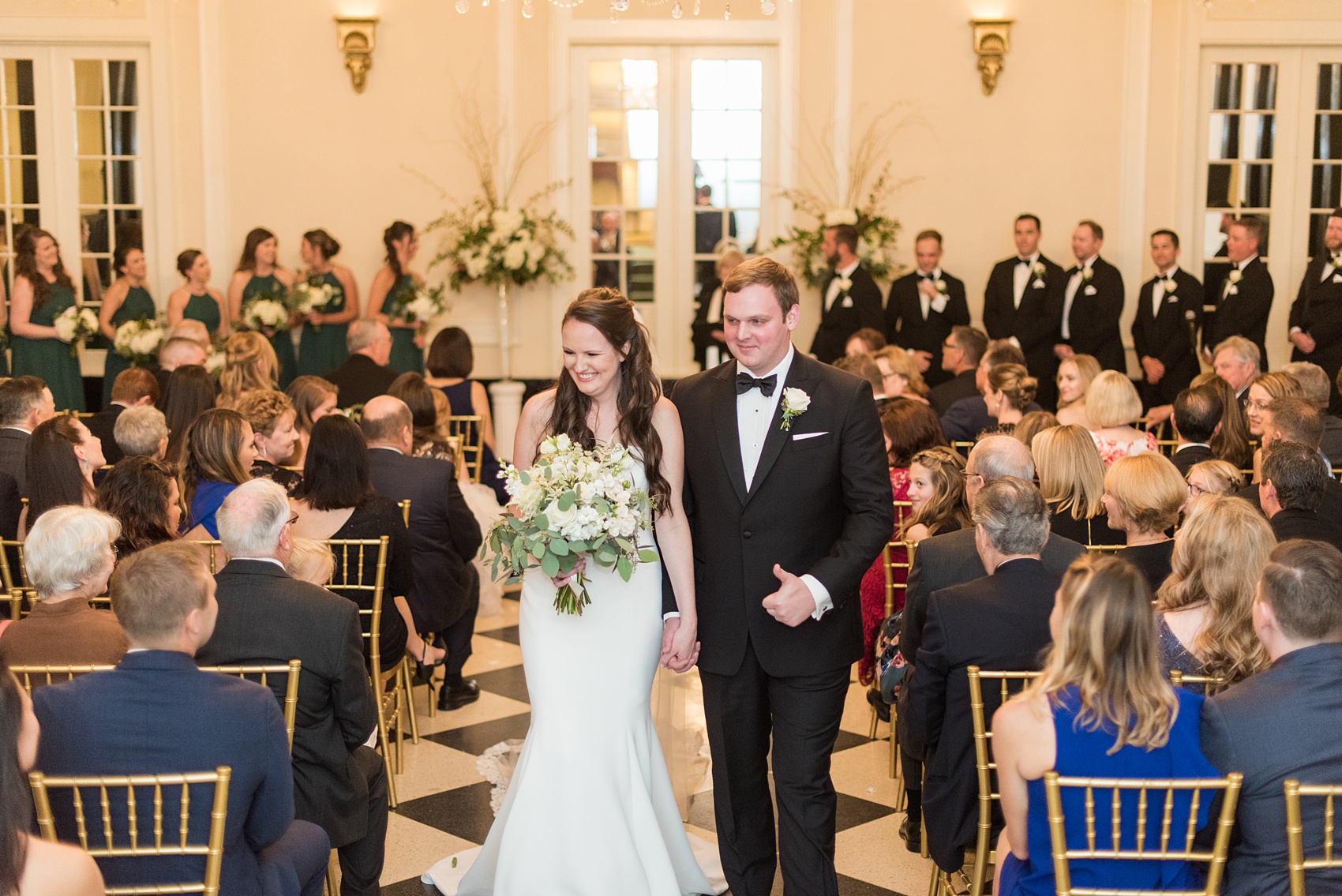 Photos of a fall wedding at The Carolina Inn, in Chapel Hill North Carolina, by Mikkel Paige Photography. This event venue doubles as a hotel for guests, who can enjoy a reception indoors or outdoors. Their ceremony was in the iconic checkerboard Old Mill room with a black and white tile floor. Click through to see inspiration from the entire wedding! Planner: @asouthernsoiree #thecarolinainn #ChapelHillWeddings #MikkelPaige #ASouthernSoiree #indoorceremony