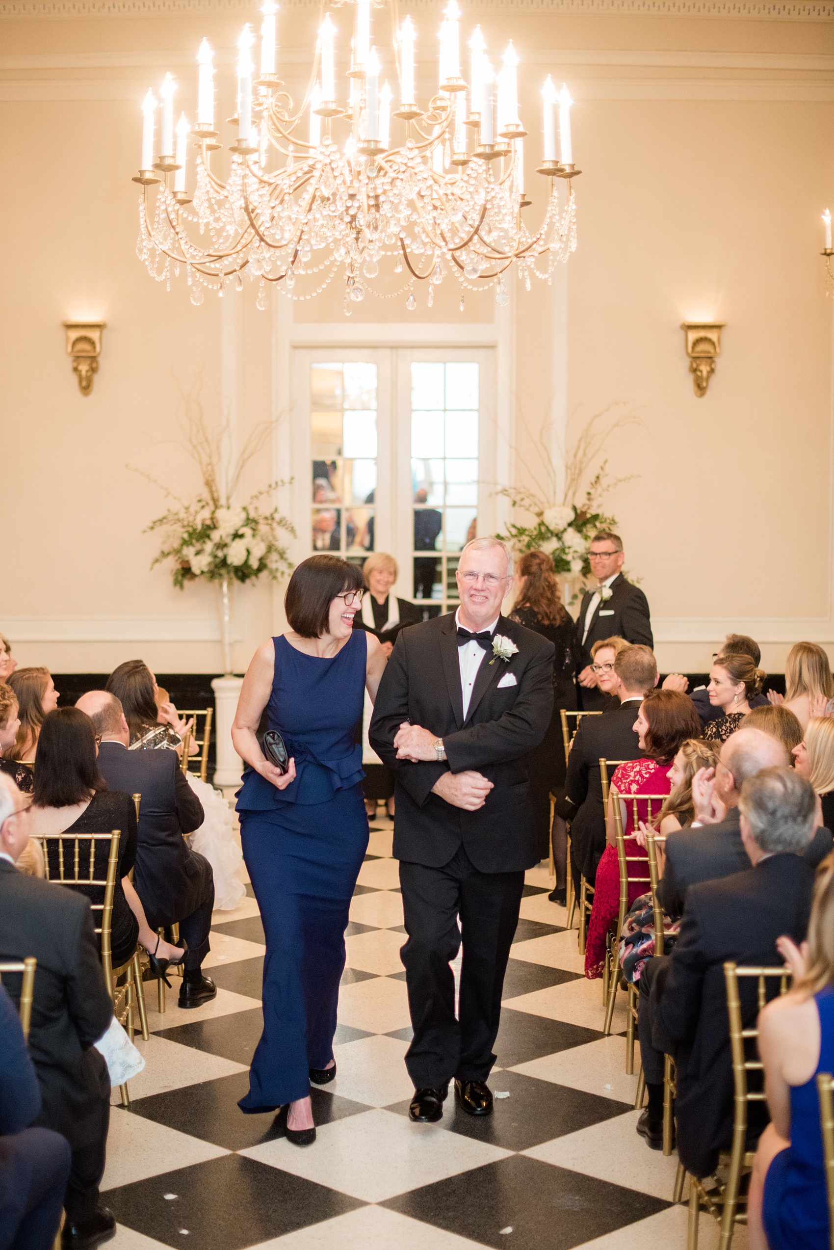 Photos of a fall wedding at The Carolina Inn, in Chapel Hill North Carolina, by Mikkel Paige Photography. This event venue doubles as a hotel for guests, who can enjoy a reception indoors or outdoors. Their ceremony was in the iconic checkerboard Old Mill room with a black and white tile floor. Click through to see inspiration from the entire wedding! Planner: @asouthernsoiree #thecarolinainn #ChapelHillWeddings #MikkelPaige #ASouthernSoiree #indoorceremony