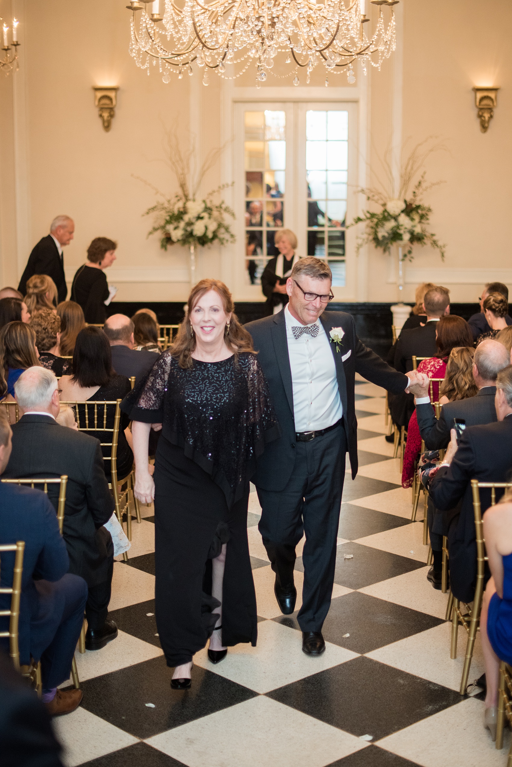 Photos of a fall wedding at The Carolina Inn, in Chapel Hill North Carolina, by Mikkel Paige Photography. This event venue doubles as a hotel for guests, who can enjoy a reception indoors or outdoors. Their ceremony was in the iconic checkerboard Old Mill room with a black and white tile floor. Click through to see inspiration from the entire wedding! Planner: @asouthernsoiree #thecarolinainn #ChapelHillWeddings #MikkelPaige #ASouthernSoiree #indoorceremony