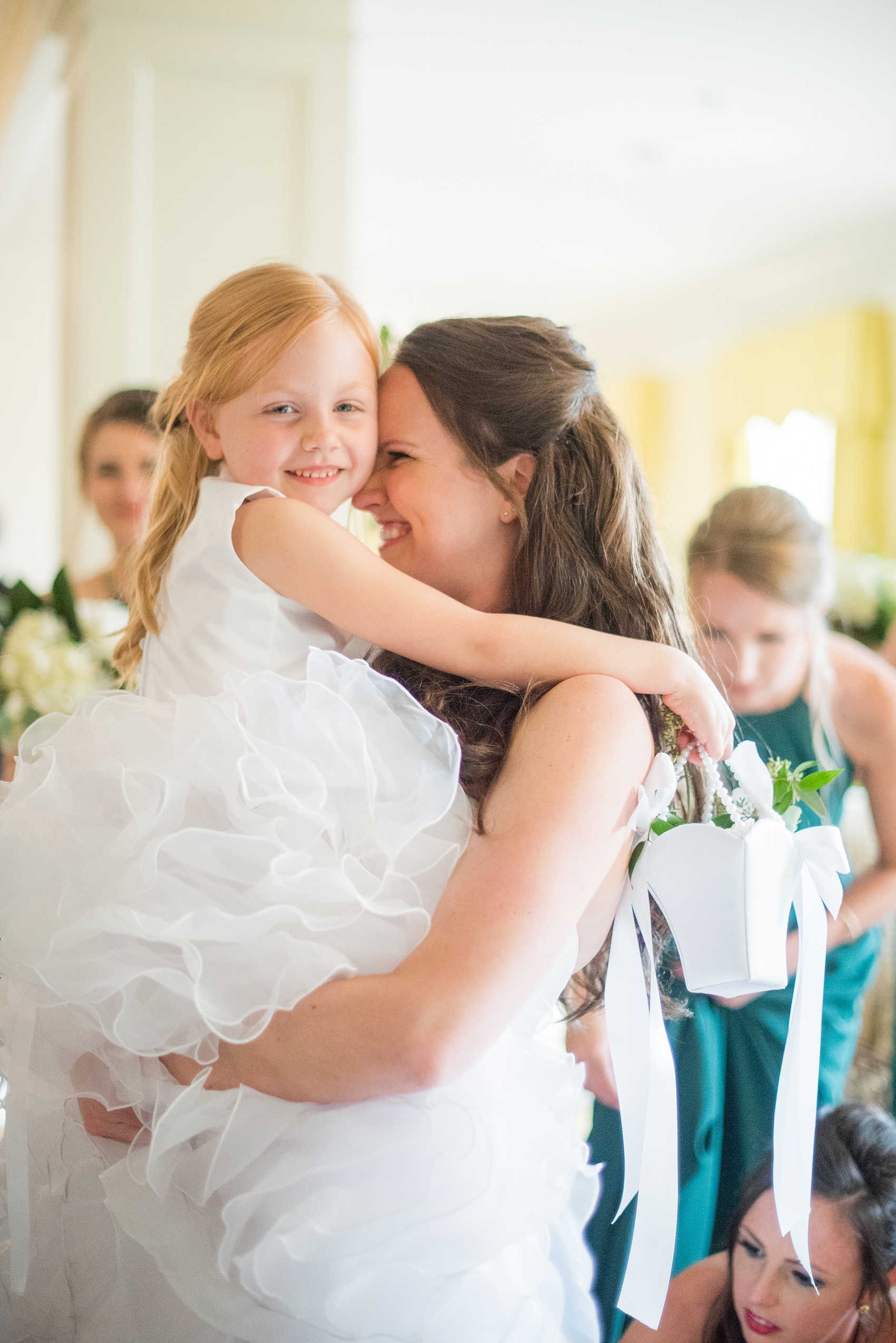 Photos of a fall wedding at The Carolina Inn, in Chapel Hill North Carolina, by Mikkel Paige Photography. This event venue doubles as a hotel for guests, who can enjoy a reception indoors or outdoors. The bride joyfully hugged the flower girl after the ceremony. Click through to see inspiration from the entire wedding! Planner: @asouthernsoiree #thecarolinainn #ChapelHillWeddings #MikkelPaige #ASouthernSoiree #flowergirl