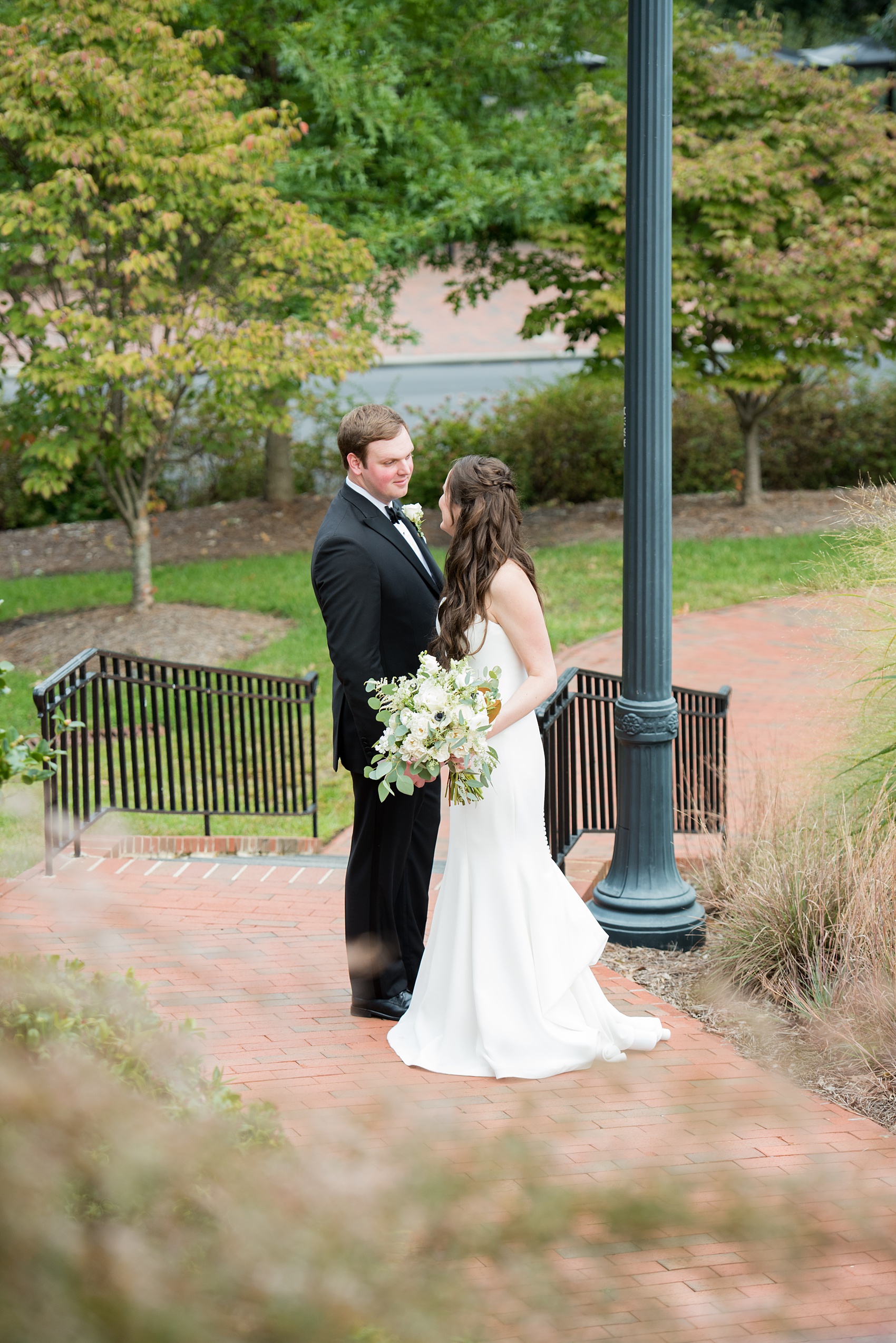 Photos of a fall wedding at The Carolina Inn, in Chapel Hill North Carolina, by Mikkel Paige Photography. This event venue doubles as a hotel for guests, who can enjoy a reception and ceremony indoors or outdoors. The bride wore a beautiful, simple white gown with a v-neck cut out and a cathedral length veil and groom a classic black tuxedo. Click through to see inspiration from the entire wedding! Planner: @asouthernsoiree #thecarolinainn #ChapelHillWeddings #MikkelPaige #bride #bridestyle