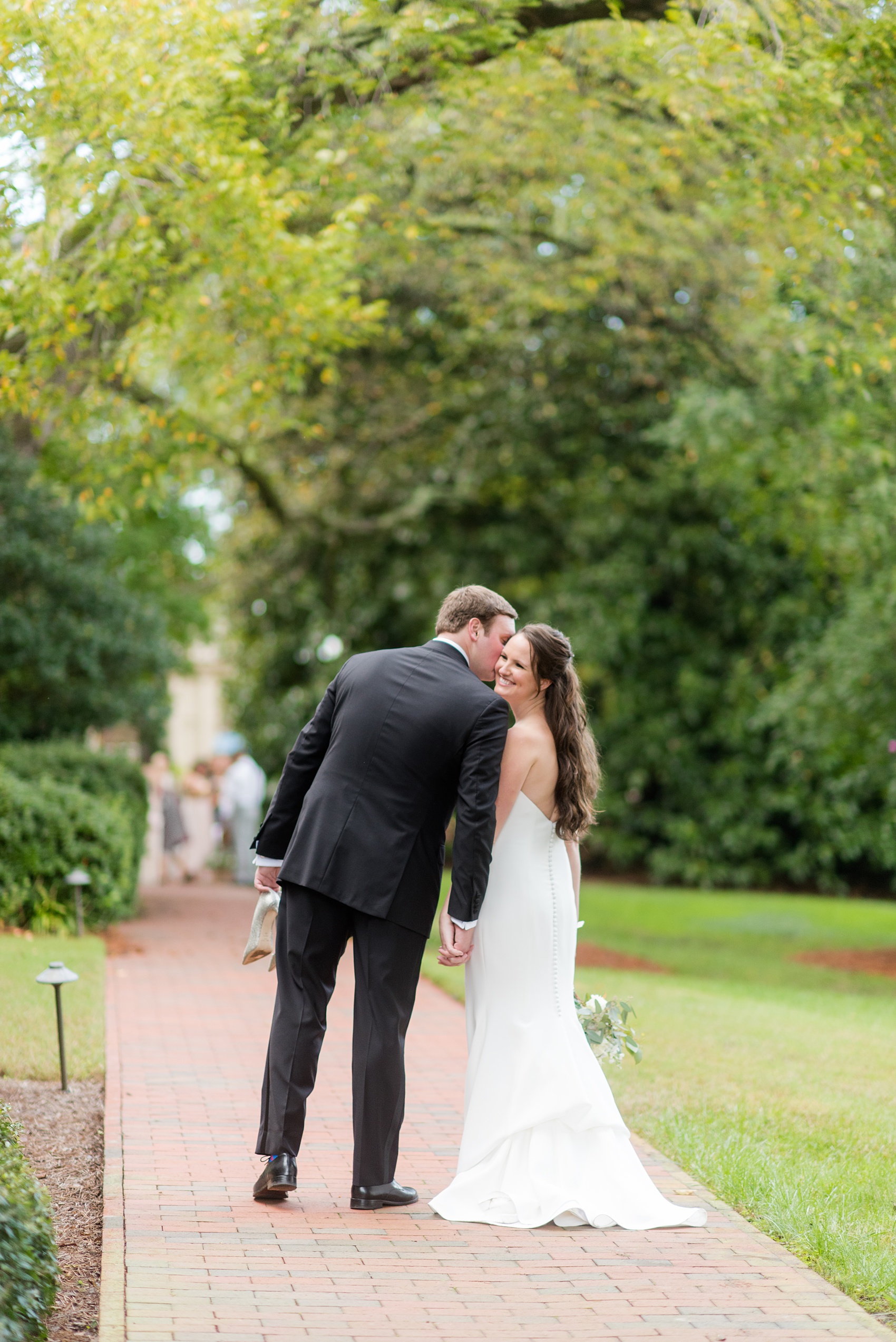 Photos of a fall wedding at The Carolina Inn, in Chapel Hill North Carolina, by Mikkel Paige Photography. This event venue doubles as a hotel for guests, who can enjoy a reception and ceremony indoors or outdoors. The bride wore a beautiful, simple white gown with a v-neck cut out and a cathedral length veil and groom a classic black tuxedo. Click through to see inspiration from the entire wedding! Planner: @asouthernsoiree #thecarolinainn #ChapelHillWeddings #MikkelPaige #bride #bridestyle