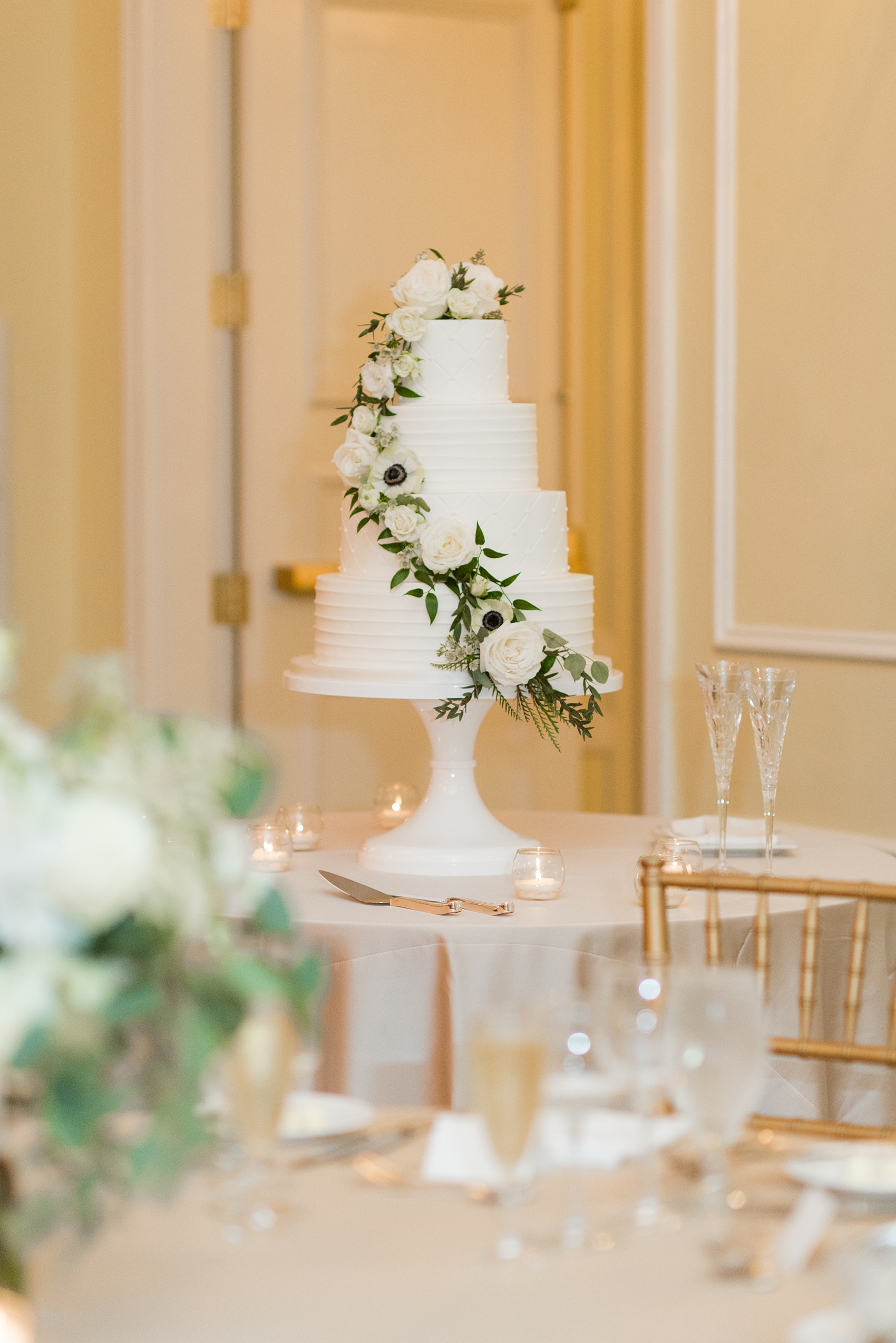 Photos of a fall wedding at The Carolina Inn, in Chapel Hill North Carolina, by Mikkel Paige Photography. This event venue doubles as a hotel for guests, with indoor and outdoor reception options. The bride and groom chose a tiered white buttercream cake with cascading flowers. Click through to see all of this wedding - you’ll love the inspiration! Planning by @asouthernsoiree Cake by Ashley Cakes NC #thecarolinainn #ChapelHillWeddings #MikkelPaige #tieredcake #cascadingflowers