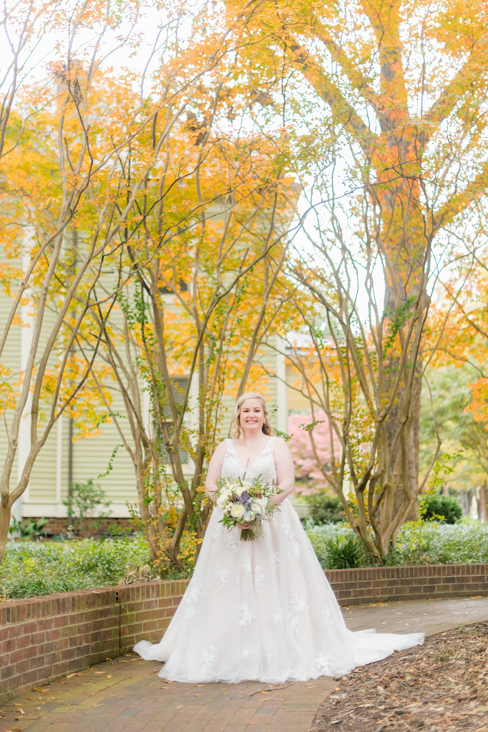 Mikkel Paige Photography captures a beautiful bridal portrait for a fall wedding in Downtown Raleigh, North Carolina. All Saints Chapel was their reception venue that they decorated with gold and silver decor and autumn centerpieces. Couple portraits were taken outdoors and the fun event continued inside the unique, and historic venue. Click through for all the details from this amazing celebration! #MikkelPaige #RaleighWeddingPhotographer #RaleighWeddingVenue #DowntownRaleighWedding