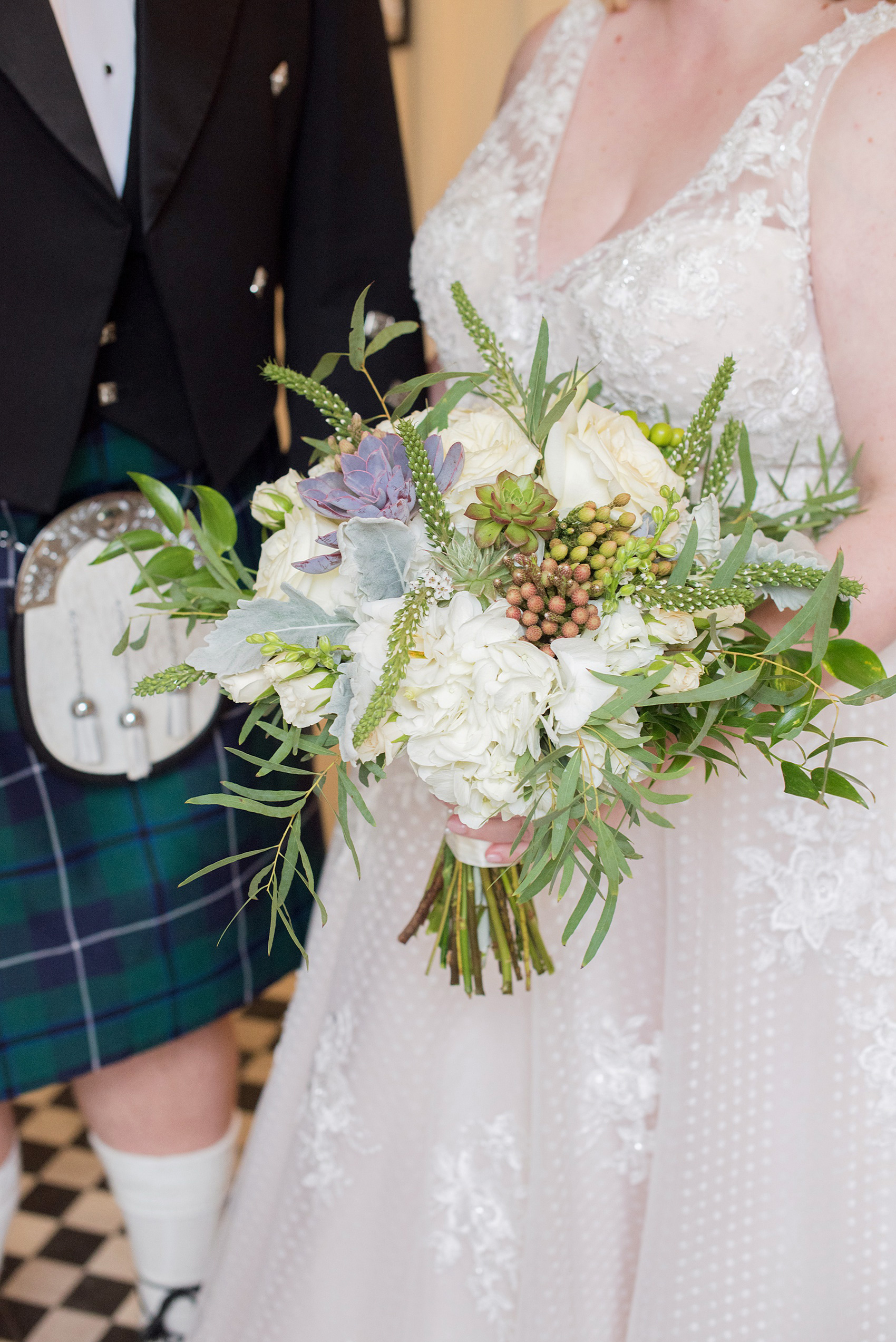 Mikkel Paige Photography captures beautiful bridal portraits and her fall bouquet during her wedding in Downtown Raleigh, North Carolina. They decorated All Saints Chapel with gold + silver decor and autumn centerpieces. The groom wore a Scottish kilt and portraits were taken outdoors. The fun event continued inside the unique, historic venue. Click through for all the details from this amazing celebration! #MikkelPaige #RaleighWeddingPhotographer #RaleighWedding #DowntownRaleighWedding #Kilt