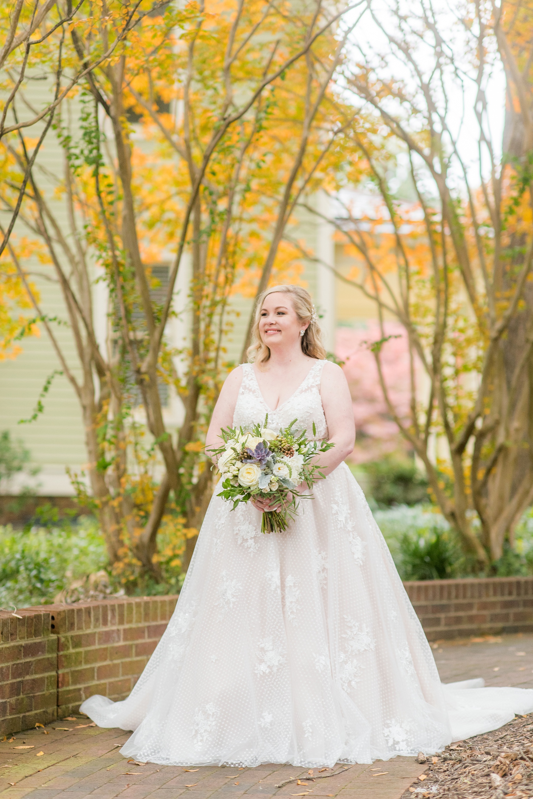 Mikkel Paige Photography captures a beautiful bridal portrait for a fall wedding in Downtown Raleigh, North Carolina. All Saints Chapel was their reception venue that they decorated with gold and silver decor and autumn centerpieces. Couple portraits were taken outdoors and the fun event continued inside the unique, and historic venue. Click through for all the details from this amazing celebration! #MikkelPaige #RaleighWeddingPhotographer #RaleighWeddingVenue #DowntownRaleighWedding