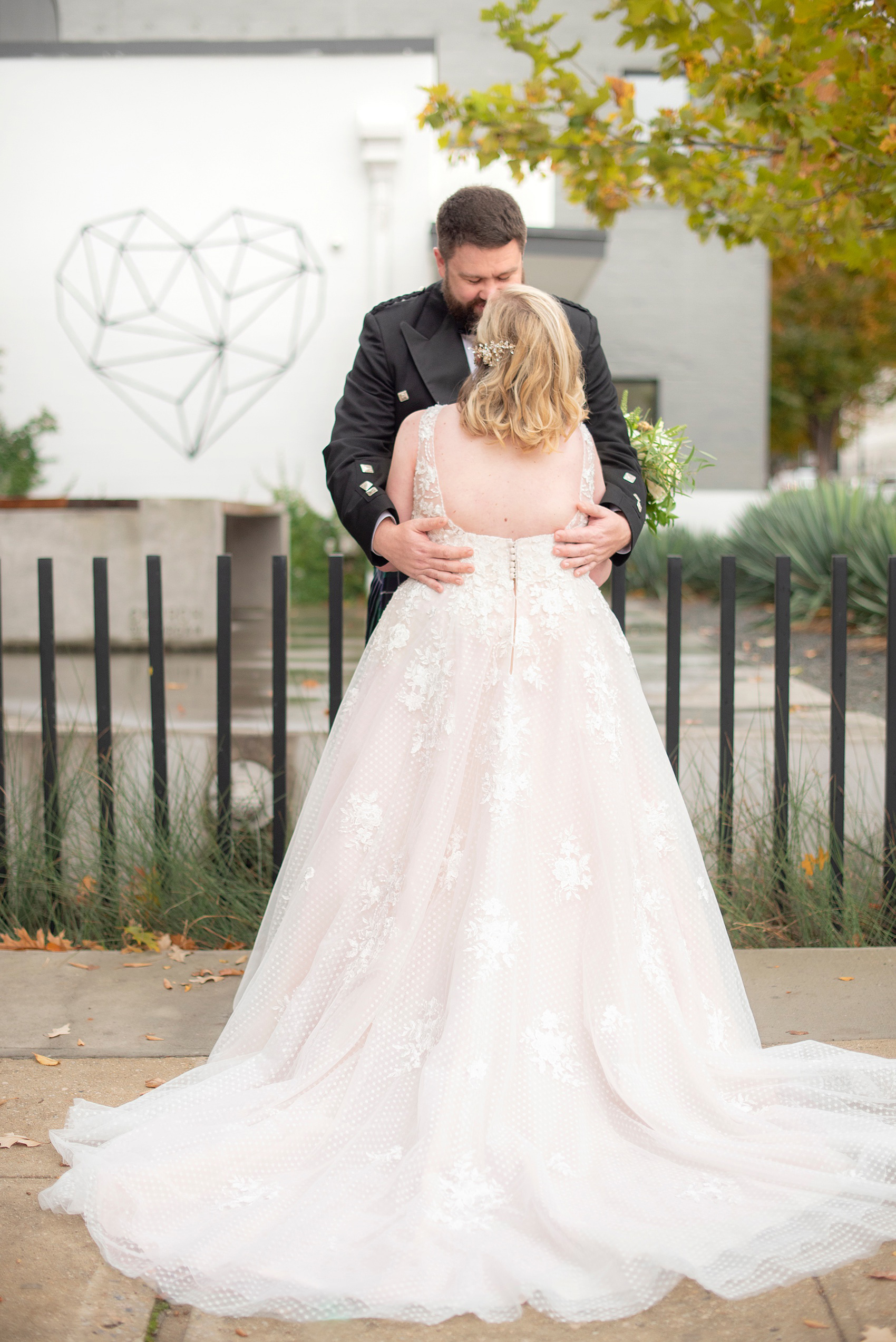 Mikkel Paige Photography captures a beautiful bride + groom during their fall wedding in Downtown Raleigh, North Carolina. All Saints Chapel was their ceremony + reception venue, which they decorated with gold + silver decor and autumn centerpieces. Couple portraits were taken outdoors and the fun event continued inside the unique, historic venue. Click through for all the details from this amazing celebration! #MikkelPaige #RaleighWeddingPhotographer #RaleighWeddingVenue #DowntownRaleighWedding