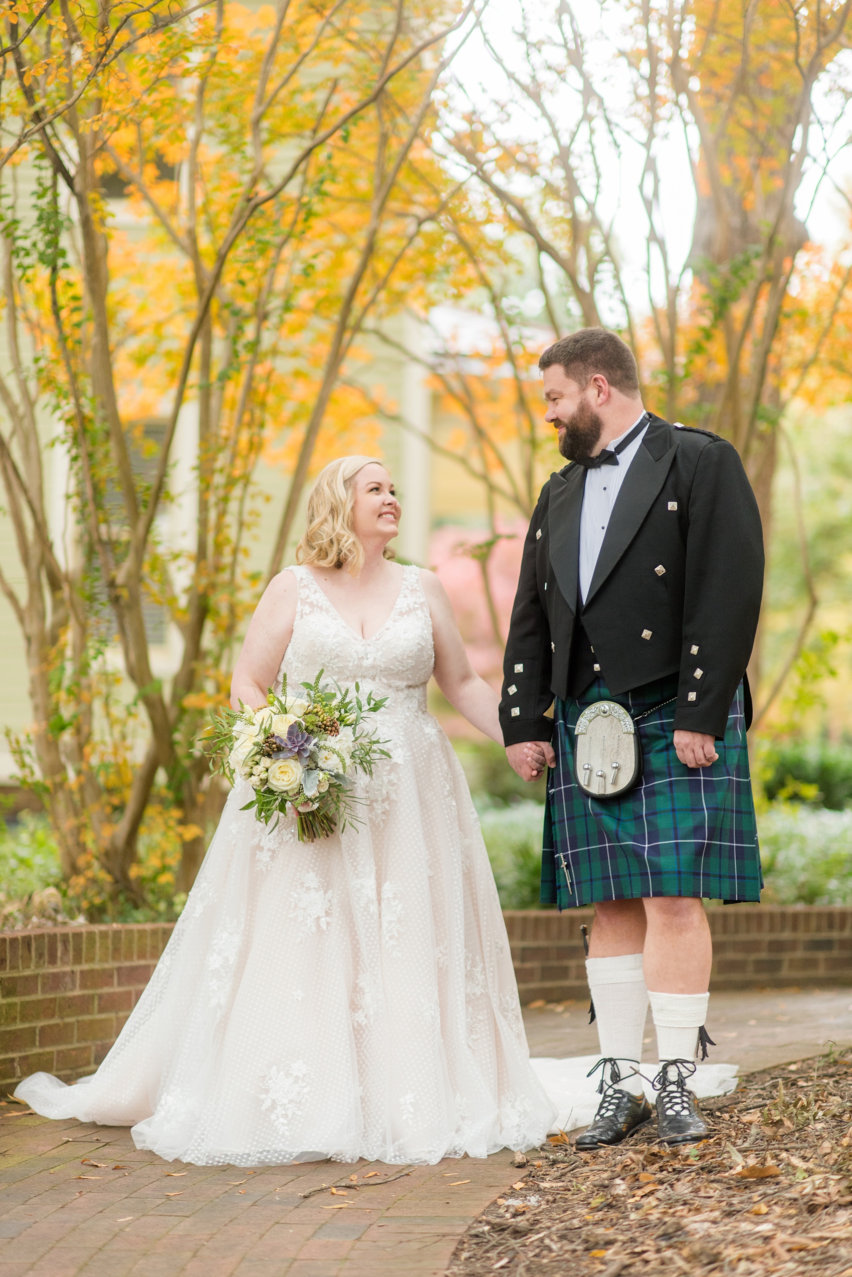 Mikkel Paige Photography captures a beautiful bride + groom during their fall wedding in Downtown Raleigh, North Carolina. All Saints Chapel was their ceremony + reception venue, which they decorated with gold + silver decor and autumn centerpieces. Couple portraits were taken outdoors and the fun event continued inside the unique, historic venue. Click through for all the details from this amazing celebration! #MikkelPaige #RaleighWeddingPhotographer #RaleighWeddingVenue #DowntownRaleighWedding