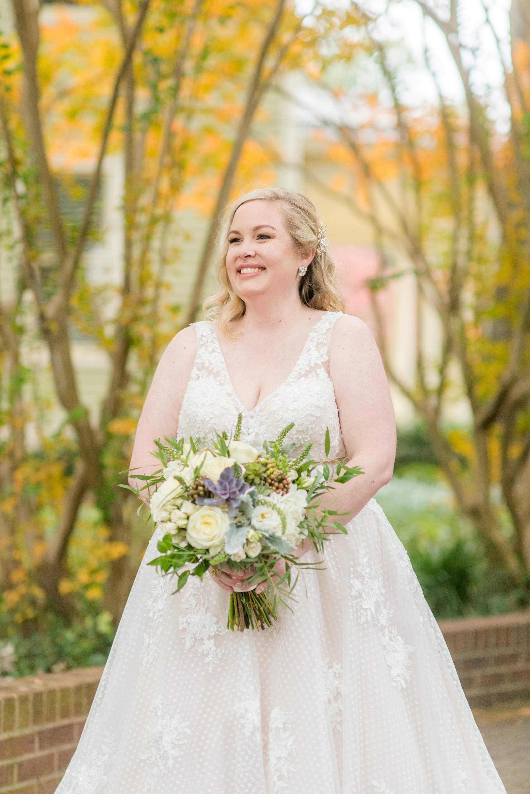 Mikkel Paige Photography captures a beautiful bride + groom during their fall wedding in Downtown Raleigh, North Carolina. All Saints Chapel was their ceremony + reception venue, which they decorated with gold + silver decor and autumn centerpieces. Couple portraits were taken outdoors and the fun event continued inside the unique, historic venue. Click through for all the details from this amazing celebration! #MikkelPaige #RaleighWeddingPhotographer #RaleighWeddingVenue #DowntownRaleighWedding