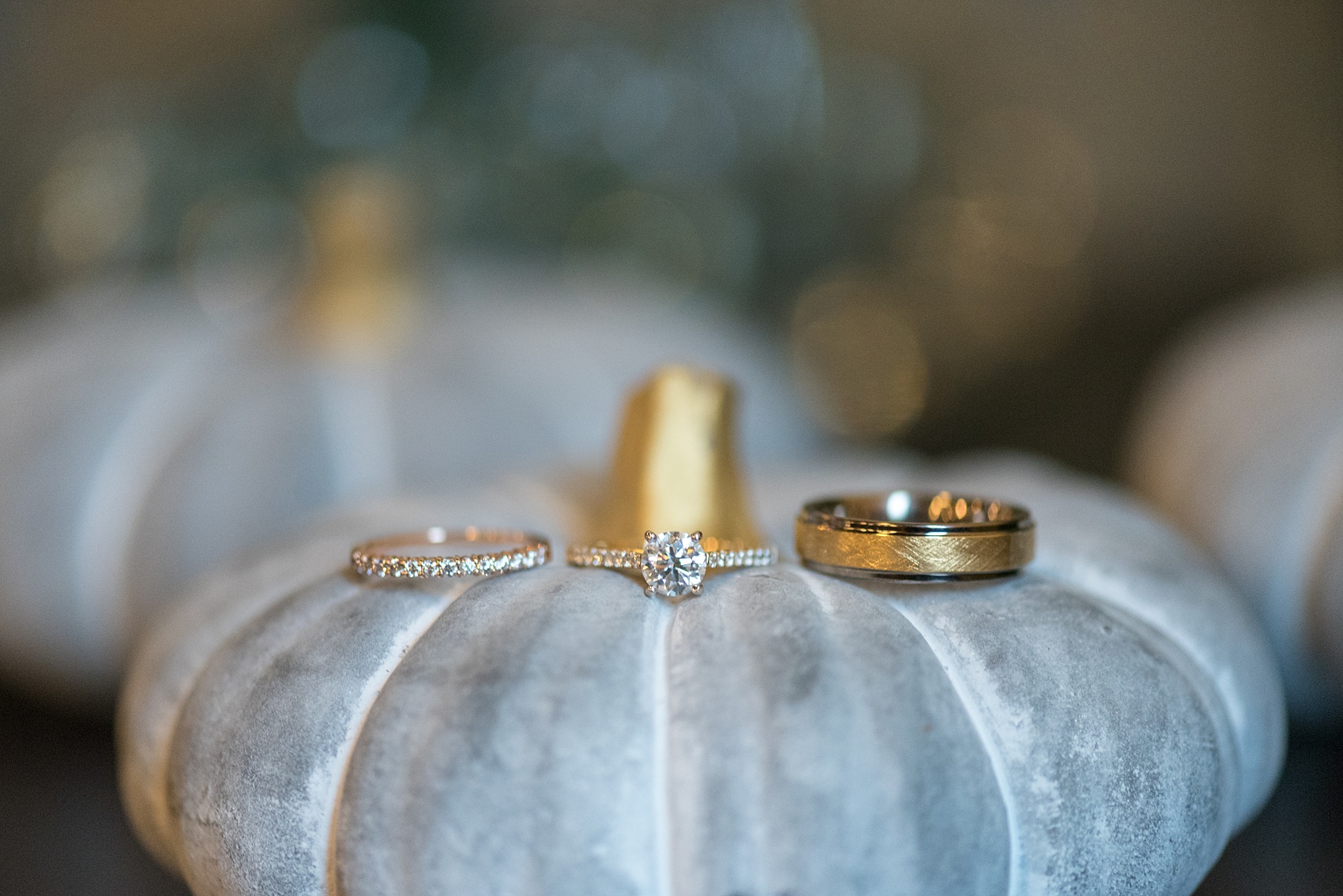 Mikkel Paige Photography captures beautiful fall wedding details Downtown Raleigh, North Carolina. Couple portraits were taken outdoors and the fun event continued inside the unique, historic venue. Yellow gold and diamond ring pictures were taken on green, fall pumpkins. Click through for all the details from this unique celebration! #MikkelPaige #RaleighWeddingPhotographer #RaleighWeddingVenue #DowntownRaleighWedding #FallWeddingDetails #RingPhotos #RingPictures