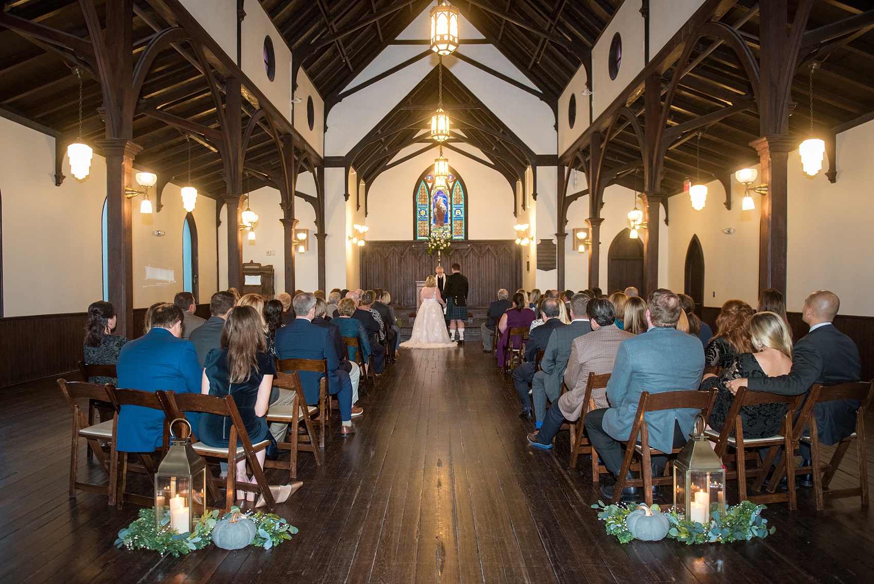 Mikkel Paige Photography captures a beautiful bride + groom during their fall wedding in Downtown Raleigh, North Carolina. All Saints Chapel was their ceremony + reception venue, which they decorated with gold + silver decor and autumn centerpieces. Couple portraits were taken outdoors and the fun event continued inside the unique, historic venue. Click through for all the details from this amazing celebration! #MikkelPaige #RaleighWeddingPhotographer #RaleighWeddingVenue #DowntownRaleighWedding