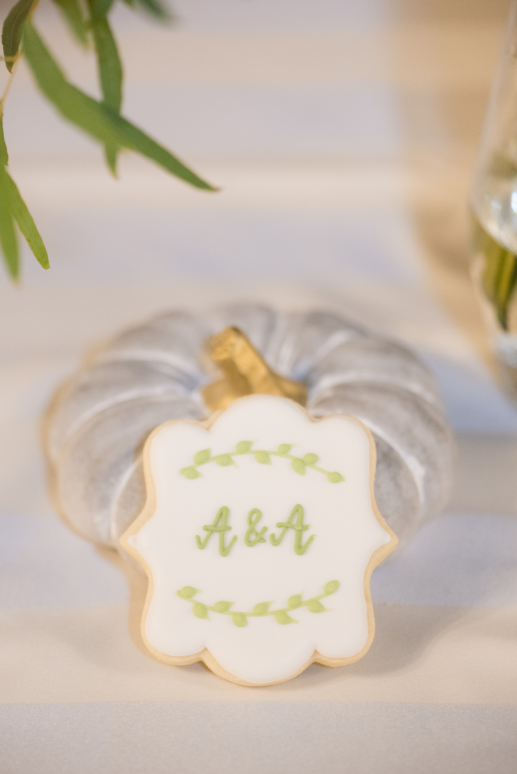 Mikkel Paige Photography captures beautiful fall wedding details Downtown Raleigh, North Carolina. Couple portraits were taken outdoors and the fun event continued inside the unique, historic venue. Custom sugar cookies were monogrammed with green frosting and the couple's initial for guest favors. Click through for all the details from this unique celebration! #MikkelPaige #RaleighWeddingPhotographer #RaleighWeddingVenue #DowntownRaleighWedding #FallWeddingDetails #sugarcookies #customcookies