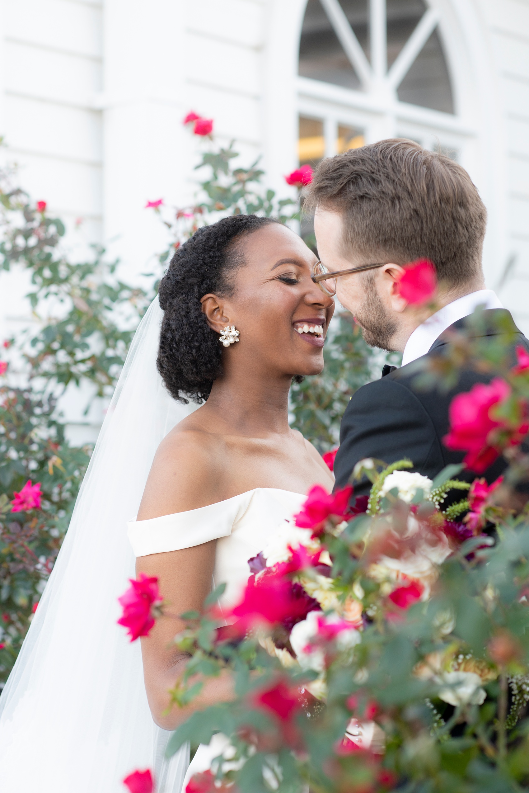 Mikkel Paige Photography photos of a wedding in Greenville, North Carolina with a beautiful mixed race couple. Their fall wedding day had warm berry red tones, including a dusty rose cinnamon bridesmaids palette and gold elements. The bride and groom shared romantic moments captured in these pictures by their Raleigh wedding photographer. Click through for more from their day! #MikkelPaige #Raleighweddingphotographer #GreenvilleNC #brideandgroom #fallwedding