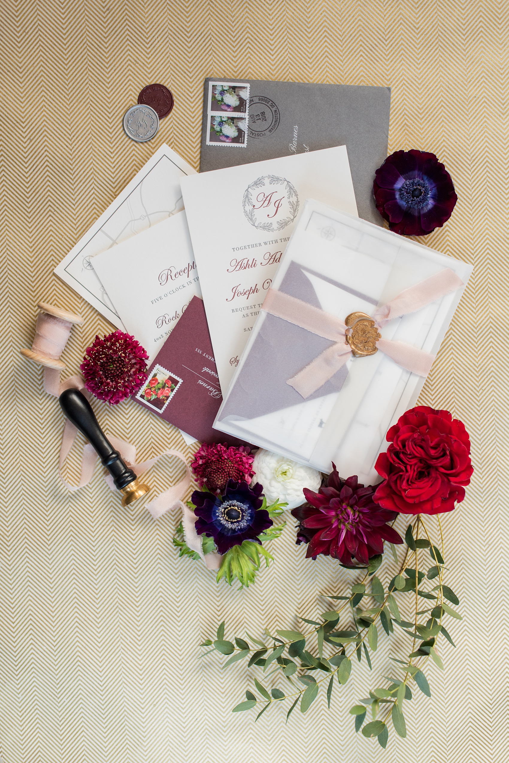 Mikkel Paige Photography photos of a wedding in Greenville, North Carolina with a beautiful mixed race couple. Their fall wedding day had warm berry red tones, including a dusty rose cinnamon bridesmaids palette and gold elements. The bride and groom chose a grey and burgundy invitation and matching wax seals and vellum for their wedding stationery. Click through for more from their day! #MikkelPaige #Raleighweddingphotographer #GreenvilleNC #weddinginvitation #fallwedding #burgundywedding