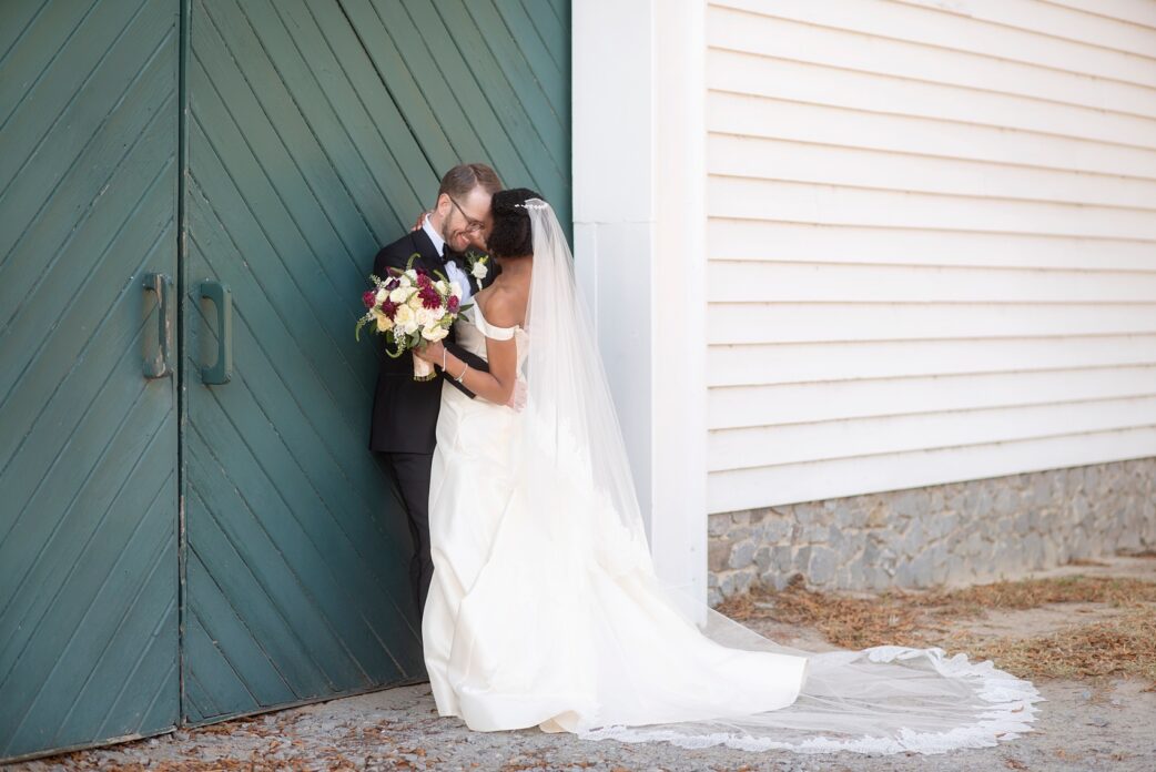 Mikkel Paige Photography photos of a wedding in Greenville, North Carolina with a beautiful mixed race couple. Their fall wedding day had warm berry red tones, including a dusty rose cinnamon bridesmaids palette and gold elements. The bride and groom shared romantic moments captured in these pictures by their Raleigh wedding photographer. Click through for more from their day! #MikkelPaige #Raleighweddingphotographer #GreenvilleNC #brideandgroom #fallwedding