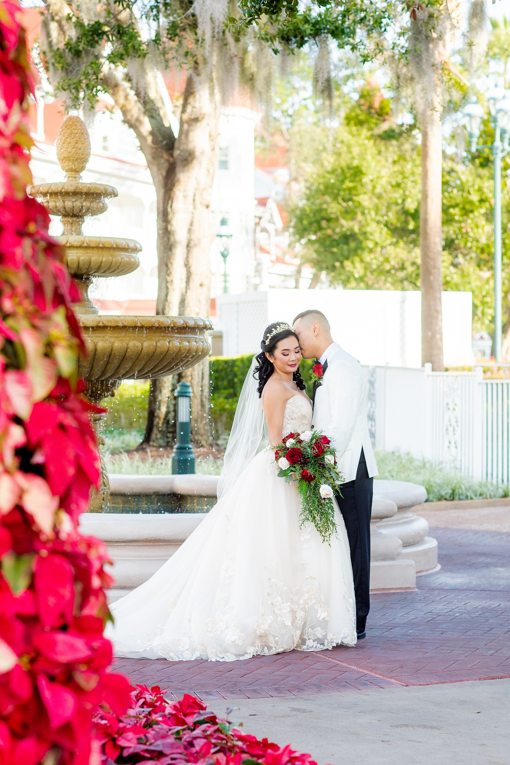 Walt Disney World wedding photos by Mikkel Paige Photography. The pictures were taken at a December wedding when the Grand Floridian and Wedding Pavilion were decorated with holiday flowers and twinkling lights! These ideas will stir a lot of inspiration for your own themed decorations whether centerpieces or bouquets. Click through for more from this fairy tale day! #mikkelpaige #disneywedding #disneyweddingphotos #disneyweddingphotographer #DisneyBride #disneyfairytalewedding