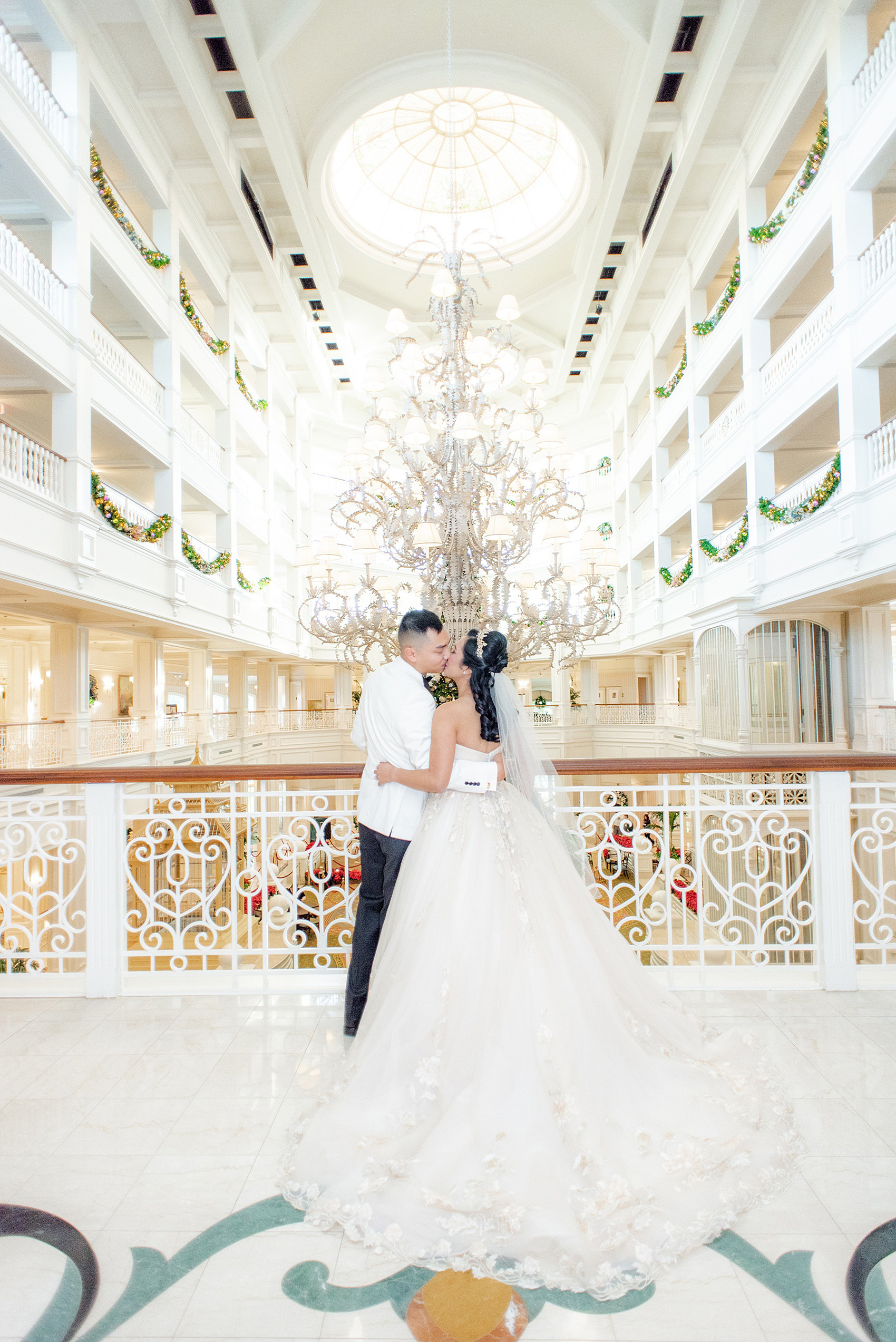 Walt Disney World wedding photos by Mikkel Paige Photography. The pictures were taken at a December wedding when the Grand Floridian and Wedding Pavilion were decorated with holiday flowers and twinkling lights! These ideas will stir a lot of inspiration for your own themed decorations whether centerpieces or bouquets. Click through for more from this fairy tale day! #mikkelpaige #disneywedding #disneyweddingphotos #disneyweddingphotographer #DisneyBride #disneyfairytalewedding