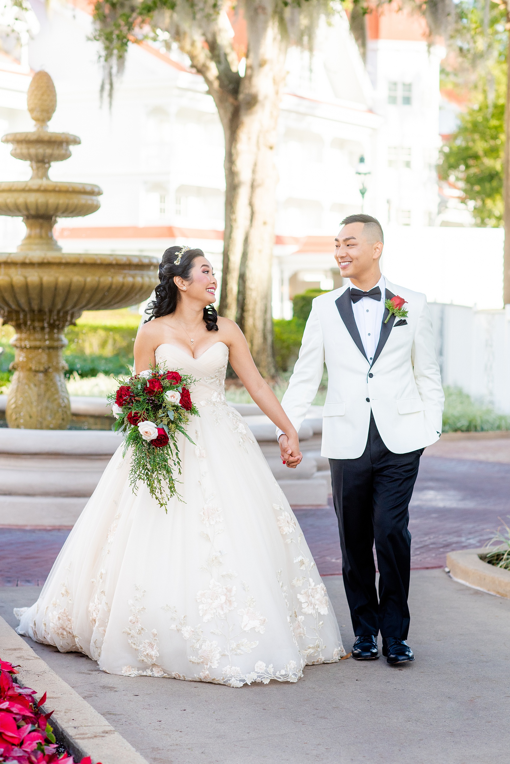 Walt Disney World wedding photos by Mikkel Paige Photography. The pictures were taken at a December wedding when the Grand Floridian and Wedding Pavilion were decorated with holiday flowers and twinkling lights! These ideas will stir a lot of inspiration for your own themed decorations whether centerpieces or bouquets. Click through for more from this fairy tale day! #mikkelpaige #disneywedding #disneyweddingphotos #disneyweddingphotographer #DisneyBride #disneyfairytalewedding