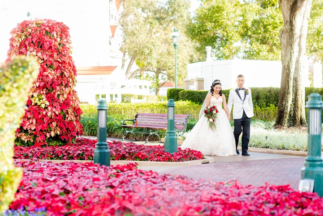 Walt Disney World wedding photos by Mikkel Paige Photography. The pictures were taken at a December wedding when the Grand Floridian and Wedding Pavilion were decorated with holiday flowers and twinkling lights! These ideas will stir a lot of inspiration for your own themed decorations whether centerpieces or bouquets. Click through for more from this fairy tale day! #mikkelpaige #disneywedding #disneyweddingphotos #disneyweddingphotographer #DisneyBride #disneyfairytalewedding