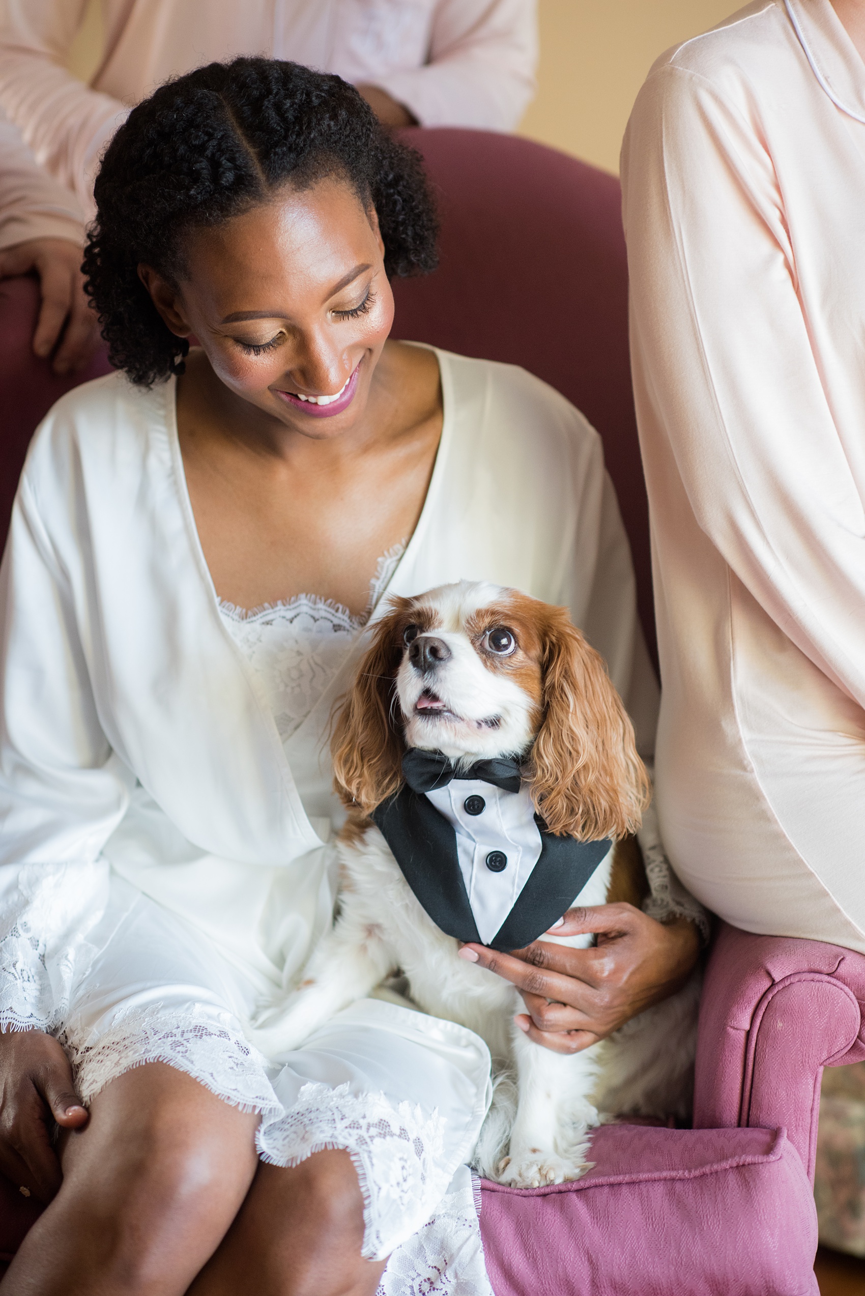 A fall wedding with burgundy, dusty rose and grey details. The bride got ready at her childhood home near the venue with her bridesmaids in monogrammed pink pajamas, with her King Charles Spaniard dog. Mikkel Paige Photography, photographer in Greenville NC and Raleigh captured this wedding at Rock Springs Center, planned by @vivalevent. Click through for more details and cute pictures from their day! #mikkelpaige #northcarolinawedding #southernwedding #gettingready #burgundywedding