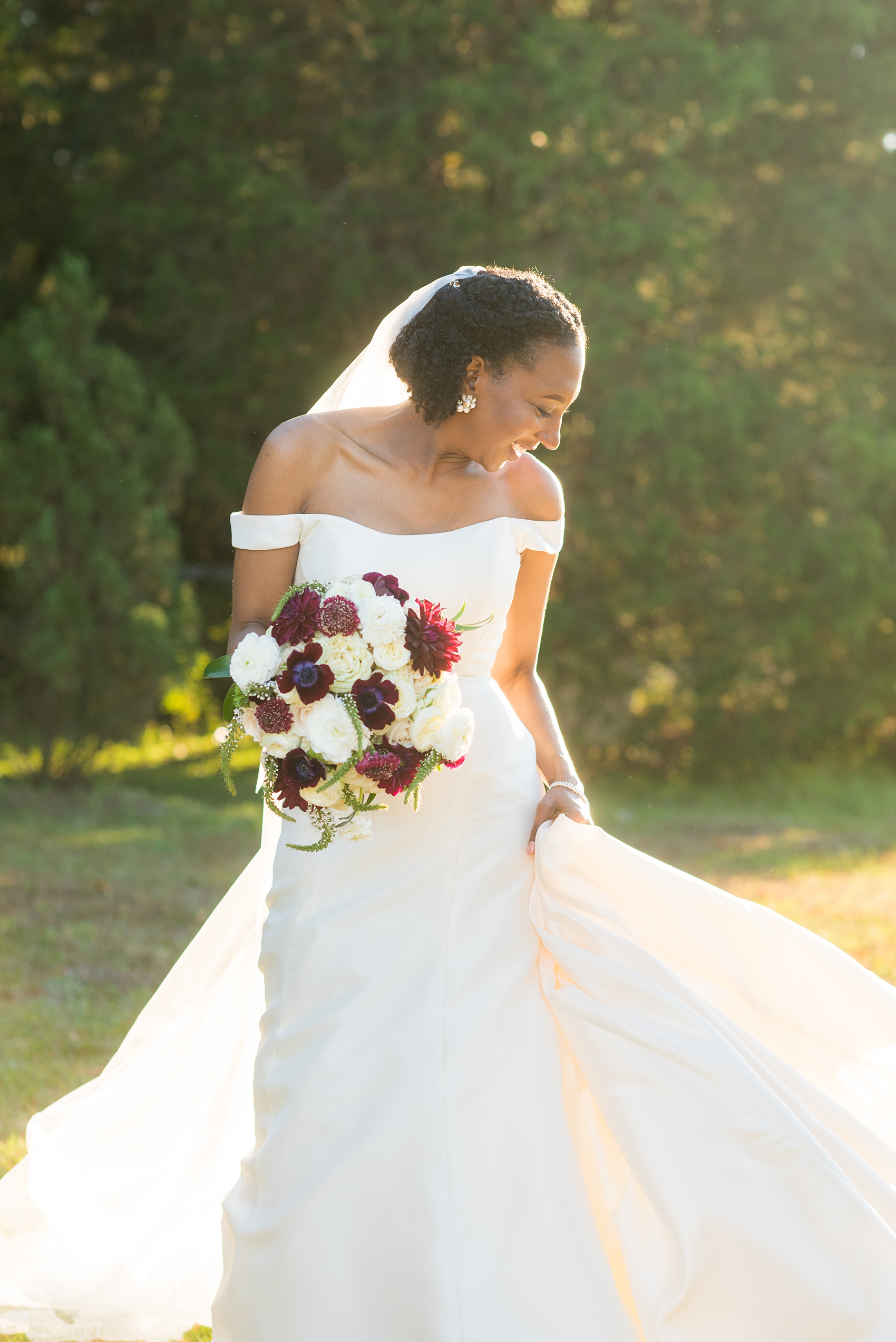 A fall wedding with burgundy, dusty rose and grey details. The bride wore an off-the-shoulder Anne Barge dress with a long veil that extended past her train. Mikkel Paige Photography, photographer in Greenville NC and Raleigh captured this wedding at Rock Springs Center, planned by @vivalevent. Click through for more details and pictures from this autumn day! #mikkelpaige #northcarolinawedding #southernwedding #burgundywedding #offtheshouldergown #annebarge #offtheshoulder #bridestyle