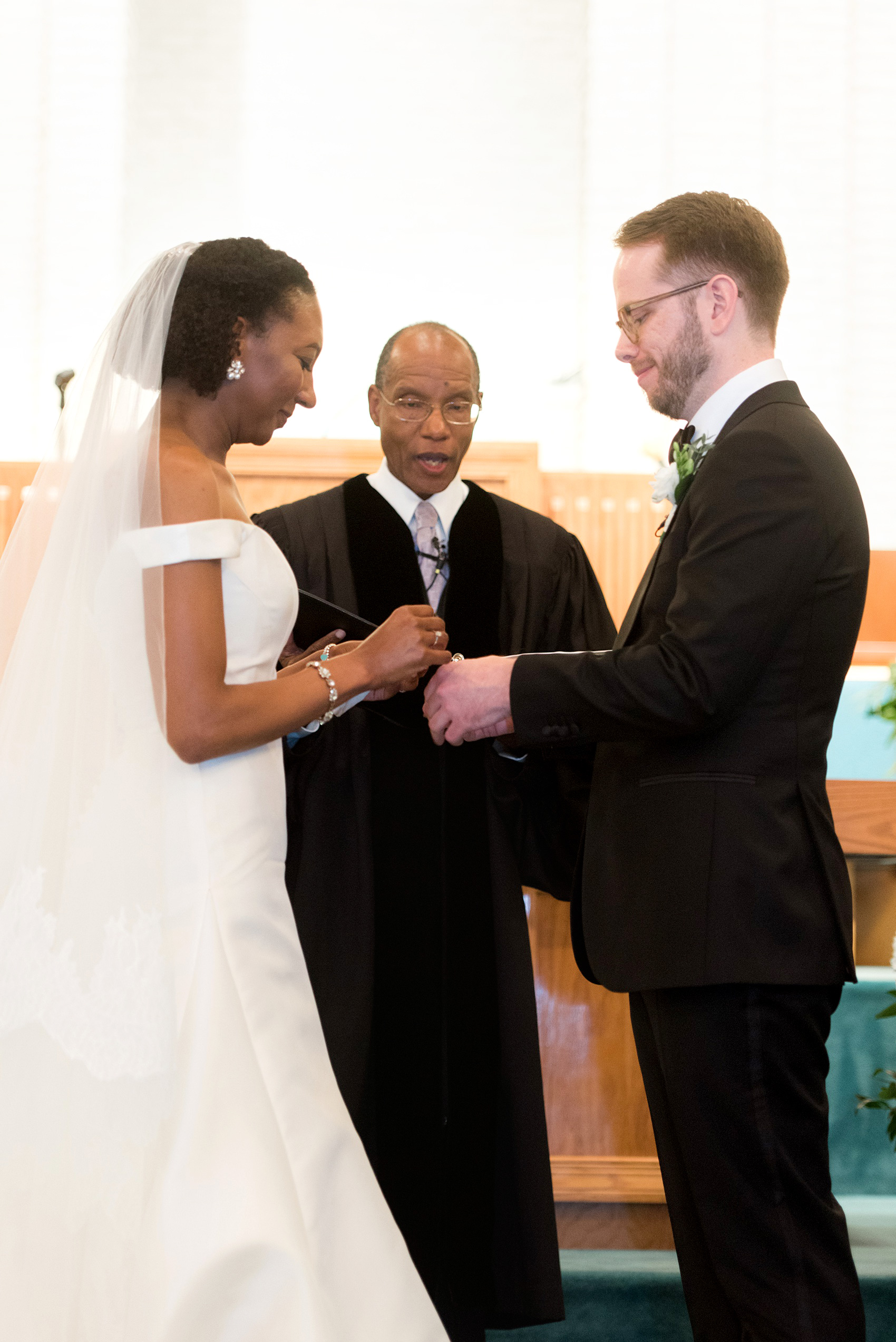 A fall wedding with burgundy, dusty rose and grey details. The bride and groom exchanged rings and vows at the bride's childhood church. Mikkel Paige Photography, photographer in Greenville NC and Raleigh captured this wedding at Rock Springs Center, planned by @vivalevent. Click through for more details and pictures from this autumn day! #mikkelpaige #northcarolinawedding #southernwedding #burgundywedding #churchceremony #ringexchange