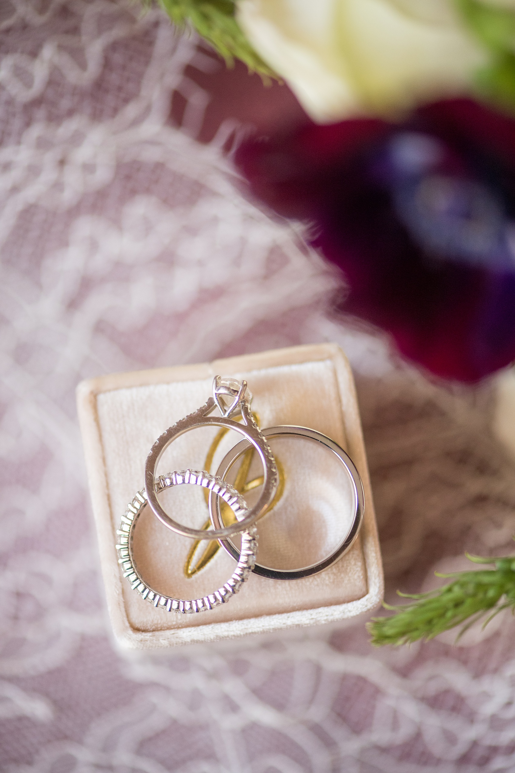 A fall wedding with burgundy, dusty rose and grey details. The couple's diamond rings, and bride's oval cut center stone engagement ring, were photographed with a pink Mrs. Box. Mikkel Paige Photography, photographer in Greenville NC and Raleigh captured this wedding at Rock Springs Center, planned by @vivalevent. Click through for more details and pictures from this autumn day! #mikkelpaige #northcarolinawedding #southernwedding #burgundywedding #themrsbox #velvetringbox #diamondrings