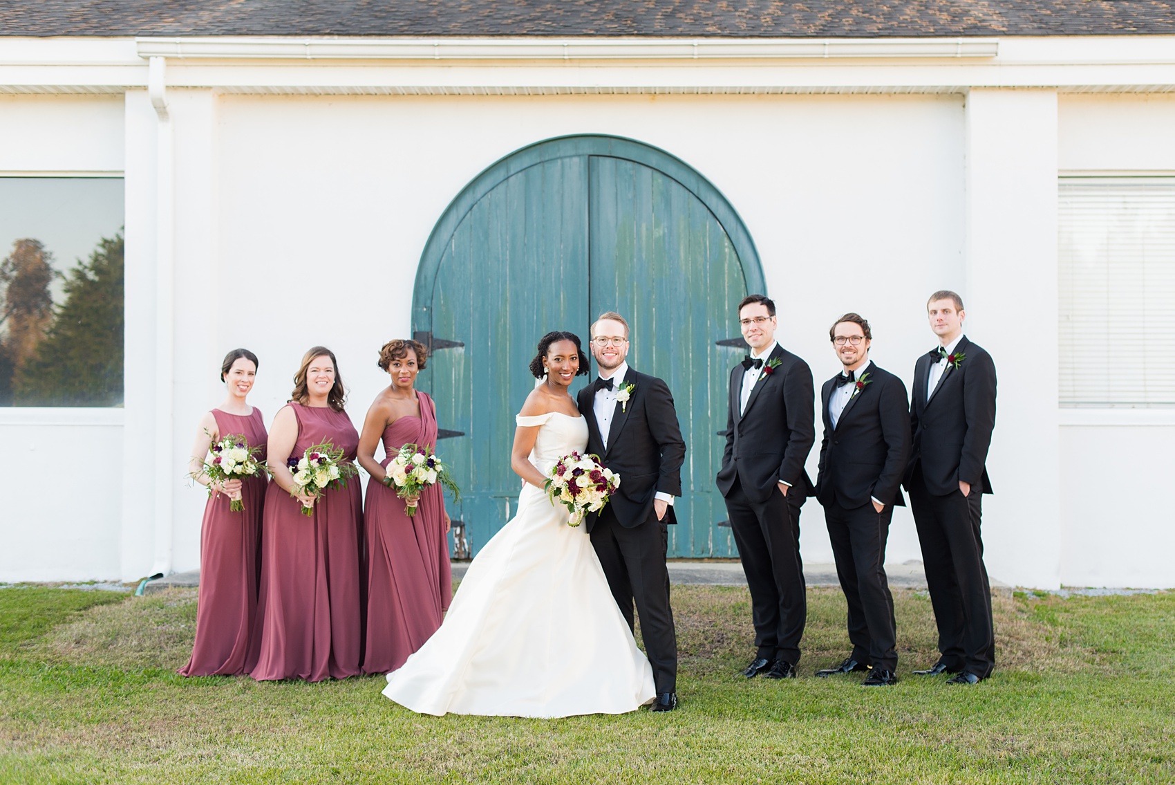A fall wedding with burgundy, dusty rose and grey details. The bride and groom had three bridesmaids and groomsmen each, with the bridesmaids in cinnamon colored gowns and groomsmen in tuxedos. Mikkel Paige Photography, photographer in Greenville NC and Raleigh captured this wedding at Rock Springs Center, planned by @vivalevent. Click through for more details and pictures from this autumn celebration! #mikkelpaige #northcarolinawedding #southernwedding #bridesmaids#weddingparty #bridalparty