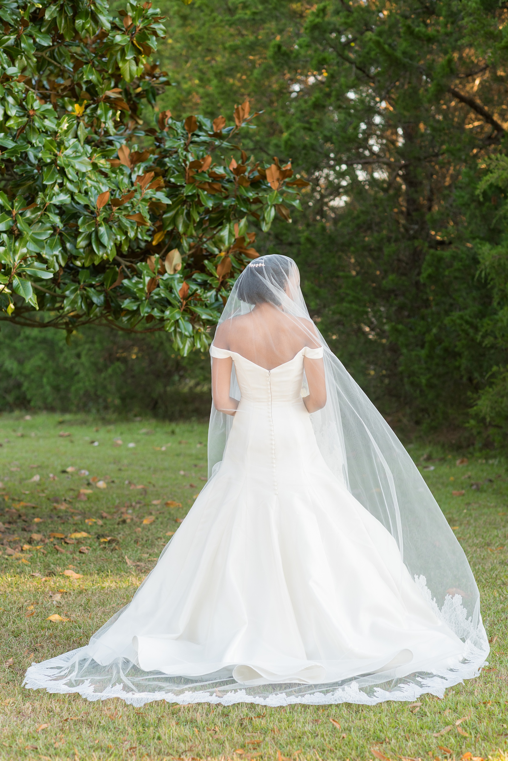 A fall wedding with burgundy, dusty rose and grey details. The bride wore an off-the-shoulder Anne Barge dress with a long veil that extended past her train. Mikkel Paige Photography, photographer in Greenville NC and Raleigh captured this wedding at Rock Springs Center, planned by @vivalevent. Click through for more details and pictures from this autumn day! #mikkelpaige #northcarolinawedding #southernwedding #burgundywedding #offtheshouldergown #annebarge #offtheshoulder #bridestyle