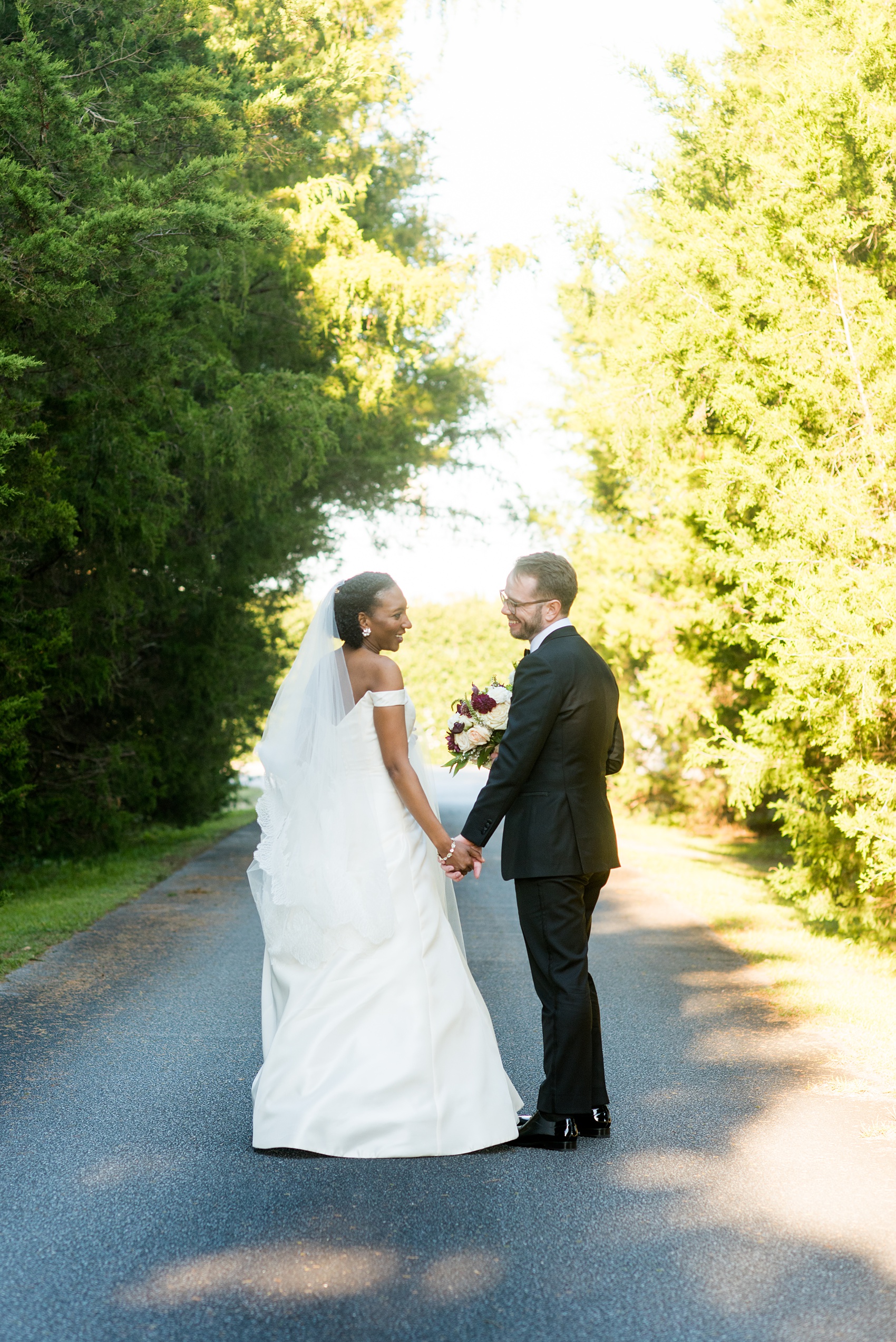 A fall wedding with burgundy, dusty rose and grey details. Mikkel Paige Photography, photographer in Greenville NC and Raleigh, captured this wedding at Rock Springs Center, planned by @vivalevent. The bride and groom had beautiful photos during golden hour on an autumn day! Click through for details! #mikkelpaige NCwedding #northcarolinawedding #southernwedding #brideandgroom