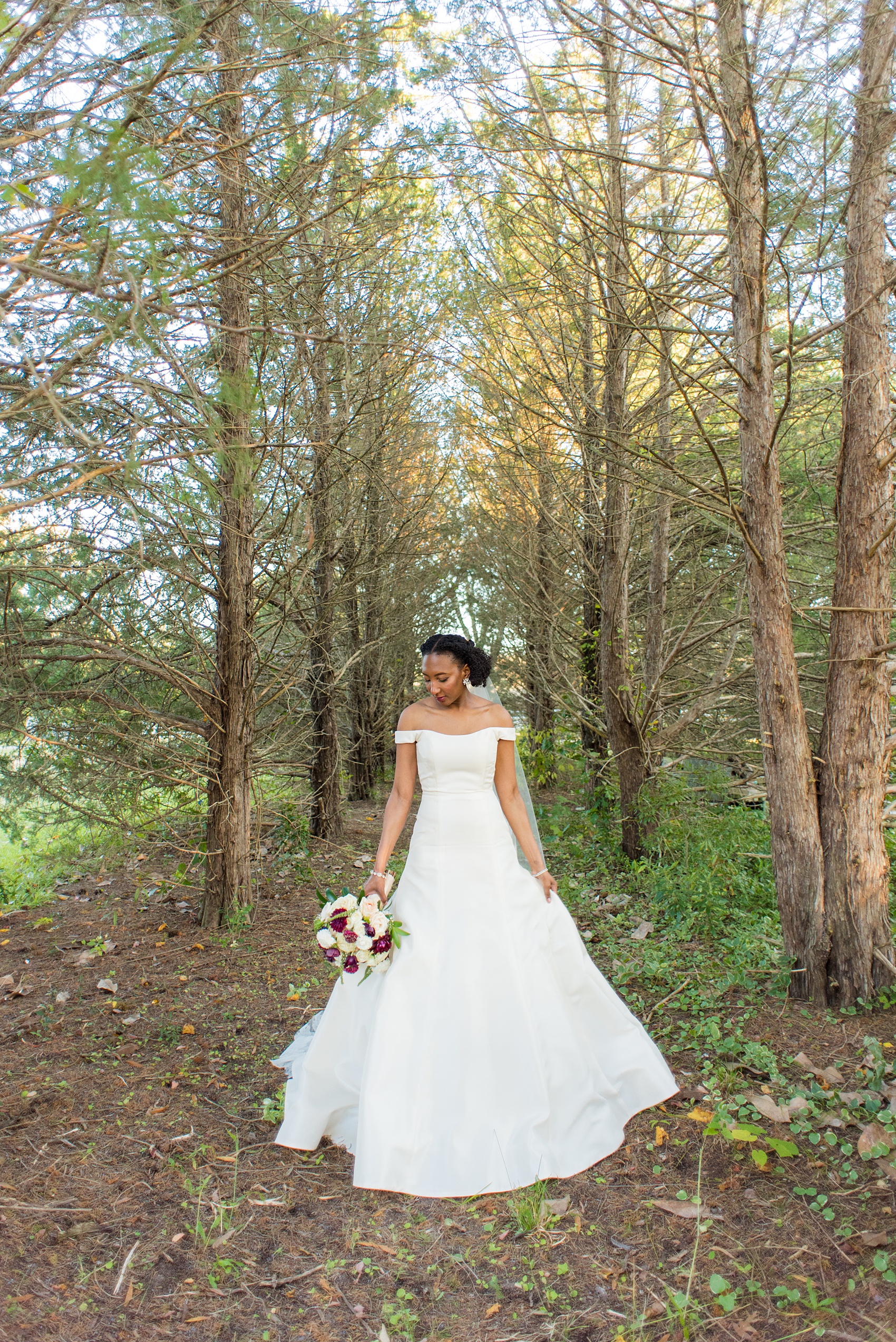 A fall wedding with burgundy, dusty rose and grey details. The bride wore an off-the-shoulder Anne Barge dress with a long veil that extended past her train. Mikkel Paige Photography, photographer in Greenville NC and Raleigh captured this wedding at Rock Springs Center, planned by @vivalevent. Click through for more details and pictures from this autumn day! #mikkelpaige #northcarolinawedding #southernwedding #burgundywedding #offtheshouldergown #annebarge #offtheshoulder #bridestyle