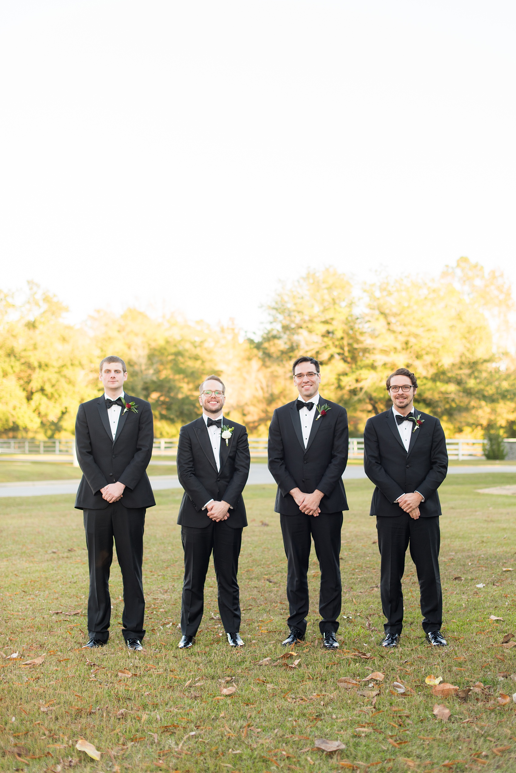 A fall wedding with burgundy, dusty rose and grey details. The bride and groom had three bridesmaids and groomsmen each, with the bridesmaids in cinnamon colored gowns and groomsmen in tuxedos. Mikkel Paige Photography, photographer in Greenville NC and Raleigh captured this wedding at Rock Springs Center, planned by @vivalevent. Click through for more details and pictures from this autumn celebration! #mikkelpaige #northcarolinawedding #southernwedding #bridesmaids#weddingparty #bridalparty