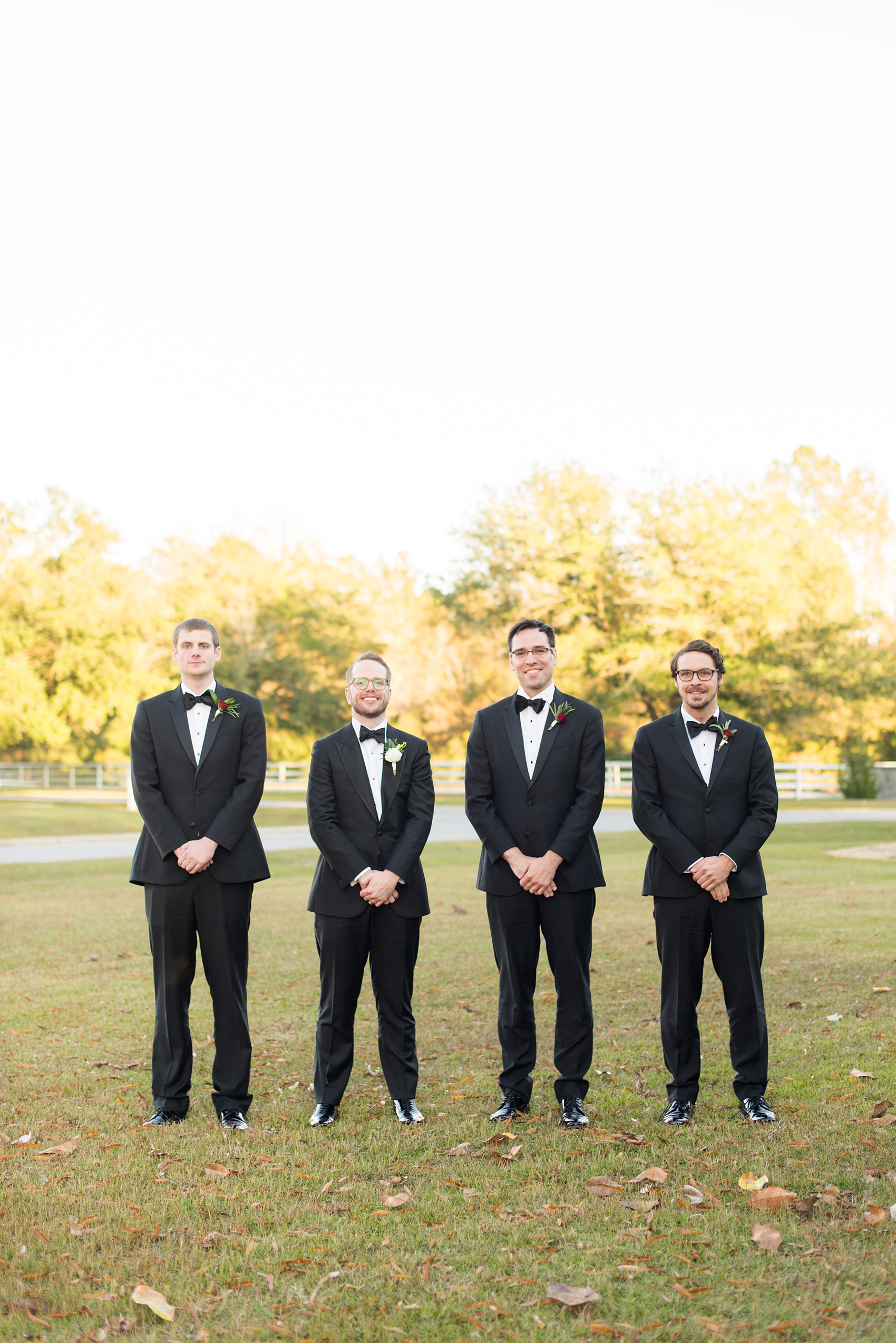 A fall wedding with burgundy, dusty rose and grey details. The bride and groom had three bridesmaids and groomsmen each, with the bridesmaids in cinnamon colored gowns and groomsmen in tuxedos. Mikkel Paige Photography, photographer in Greenville NC and Raleigh captured this wedding at Rock Springs Center, planned by @vivalevent. Click through for more details and pictures from this autumn celebration! #mikkelpaige #northcarolinawedding #southernwedding #bridesmaids#weddingparty #bridalparty