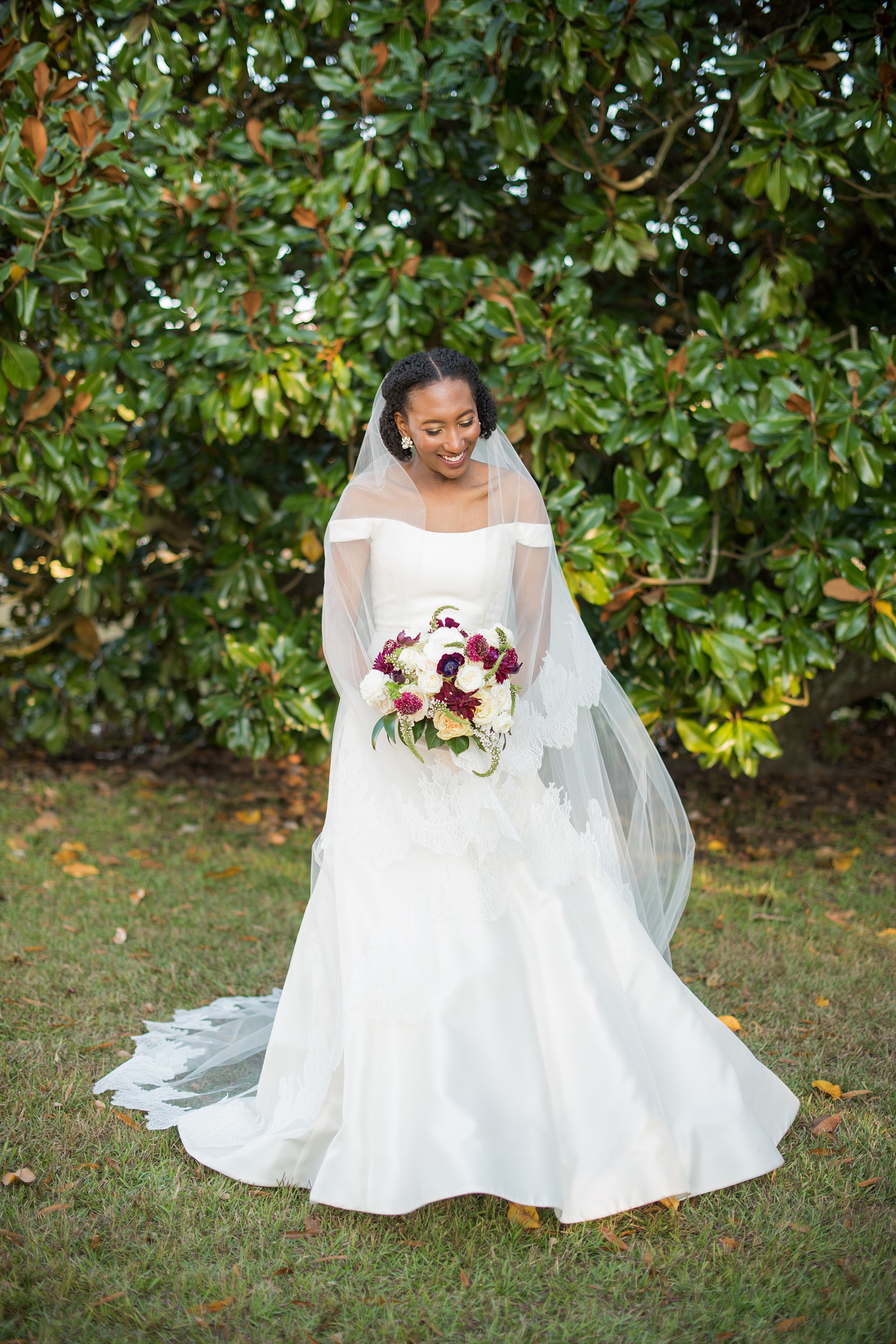 A fall wedding with burgundy, dusty rose and grey details. The bride wore an off-the-shoulder Anne Barge dress with a long veil that extended past her train. Mikkel Paige Photography, photographer in Greenville NC and Raleigh captured this wedding at Rock Springs Center, planned by @vivalevent. Click through for more details and pictures from this autumn day! #mikkelpaige #northcarolinawedding #southernwedding #burgundywedding #offtheshouldergown #annebarge #offtheshoulder #bridestyle