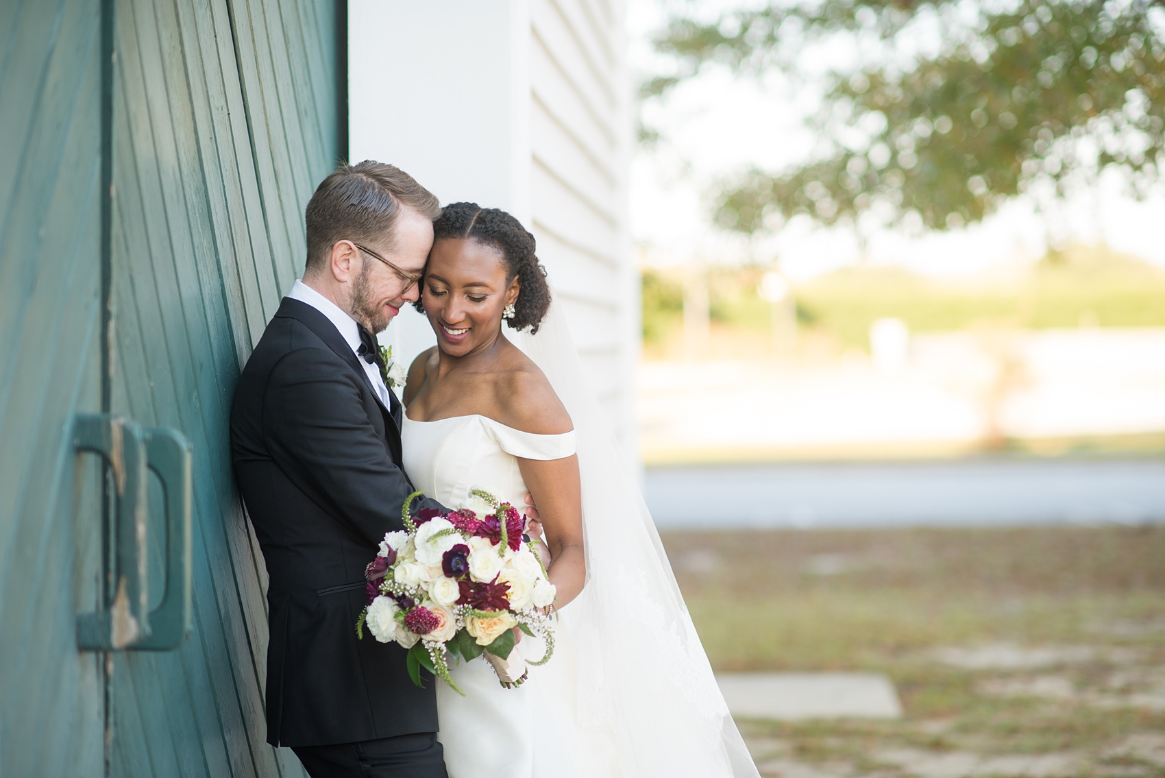 A fall wedding with burgundy, dusty rose and grey details. Mikkel Paige Photography, photographer in Greenville NC and Raleigh, captured this wedding at Rock Springs Center, planned by @vivalevent. The bride and groom had beautiful photos during golden hour on an autumn day! Click through for details! #mikkelpaige NCwedding #northcarolinawedding #southernwedding #brideandgroom