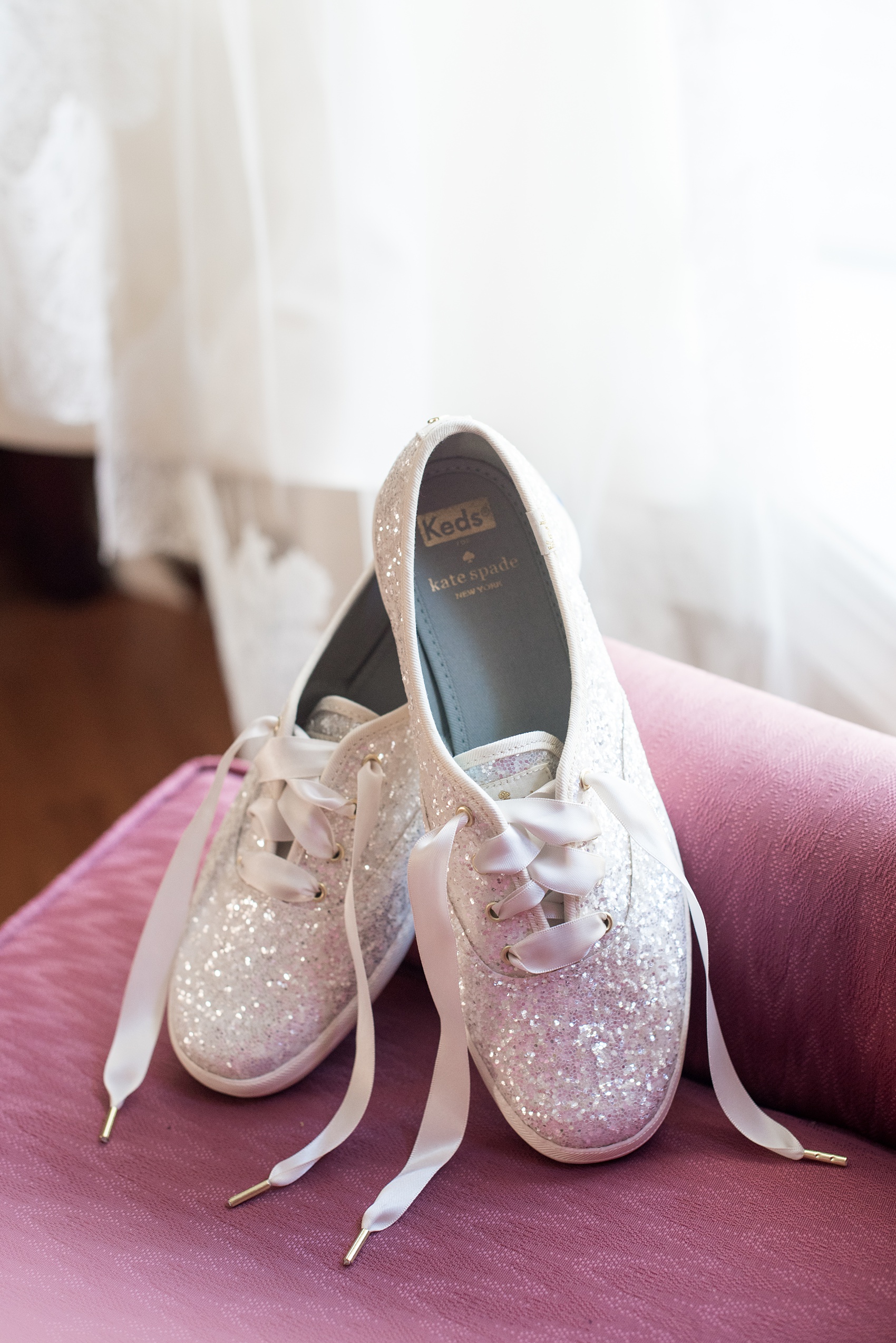 A fall wedding with burgundy, dusty rose and grey details. The bride wore sparkly white glitter Keds for their reception dancing. Mikkel Paige Photography, photographer in Greenville NC and Raleigh captured this wedding at Rock Springs Center, planned by @vivalevent. Click through for more details and pictures from this autumn celebration! #mikkelpaige #northcarolinawedding #southernwedding #bridestyle #BridalKeds #WeddingKeds #Keds #GlitterKeds