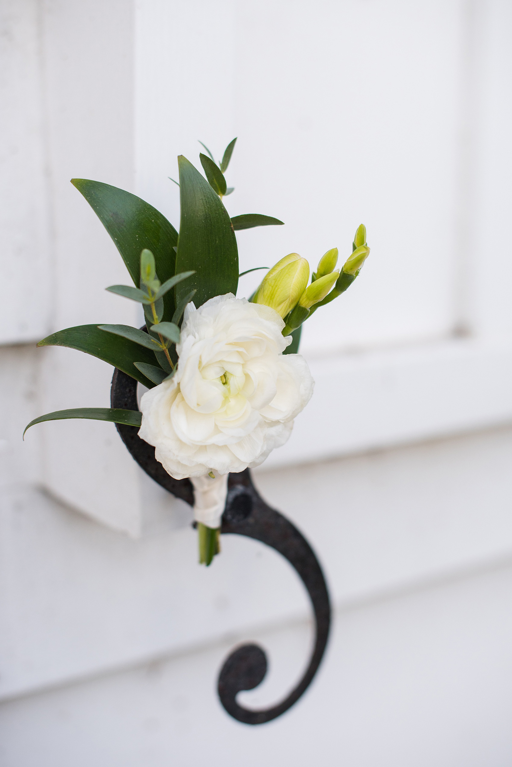 A fall wedding with burgundy, dusty rose and grey details. The groom wore a white ranunculus boutonniere with greenery in it. Mikkel Paige Photography, photographer in Greenville NC and Raleigh captured this wedding at Rock Springs Center, planned by @vivalevent. Click through for more details and pictures from this autumn day! #mikkelpaige #northcarolinawedding #southernwedding #burgundywedding #fallflowers #groomstyle #ranunculus #boutonniere