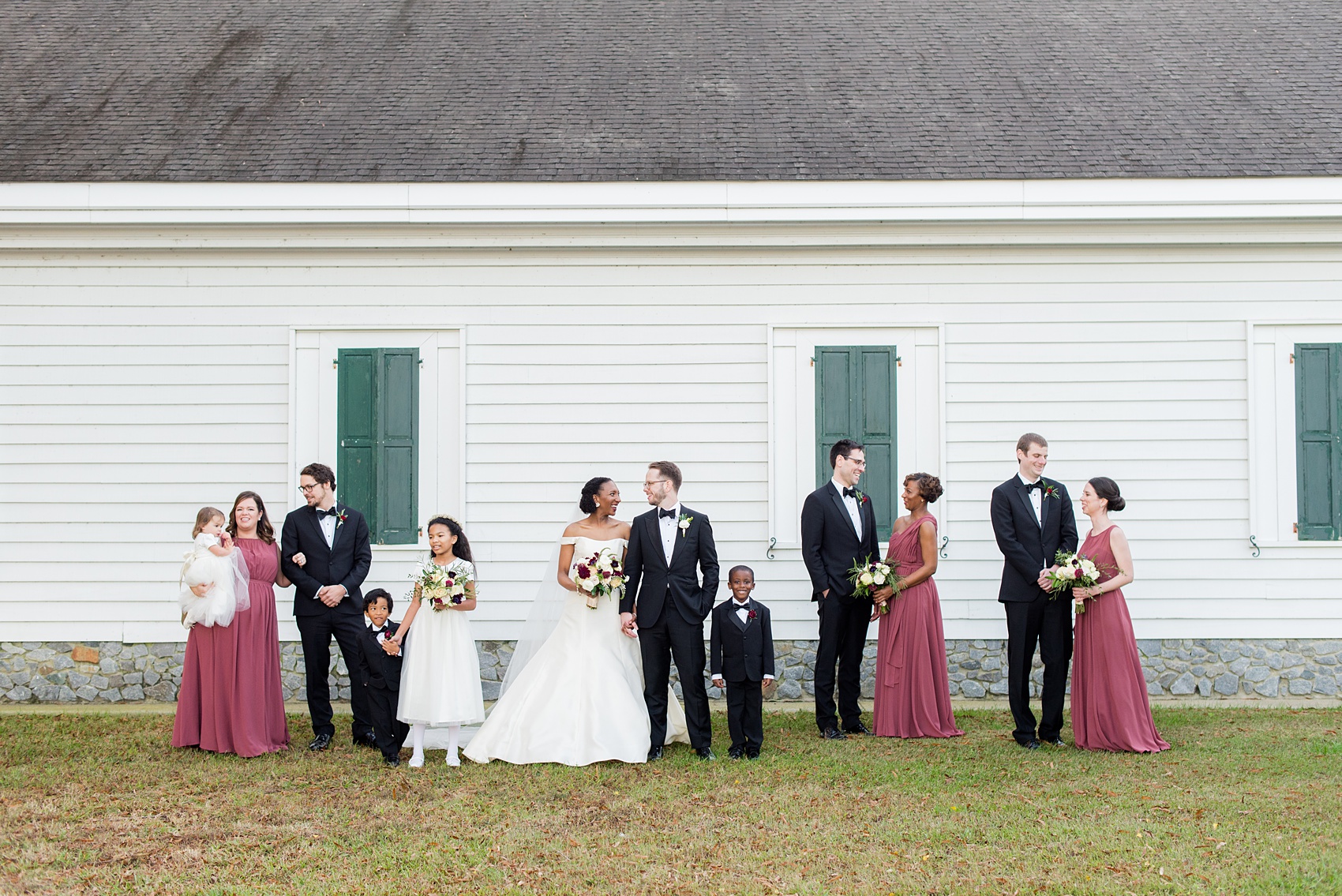 A fall wedding with burgundy, dusty rose and grey details. The bride and groom had three bridesmaids and groomsmen each, with the bridesmaids in cinnamon colored gowns and groomsmen in tuxedos. Mikkel Paige Photography, photographer in Greenville NC and Raleigh captured this wedding at Rock Springs Center, planned by @vivalevent. Click through for more details and pictures from this autumn celebration! #mikkelpaige #northcarolinawedding #southernwedding #bridesmaids#weddingparty #bridalparty
