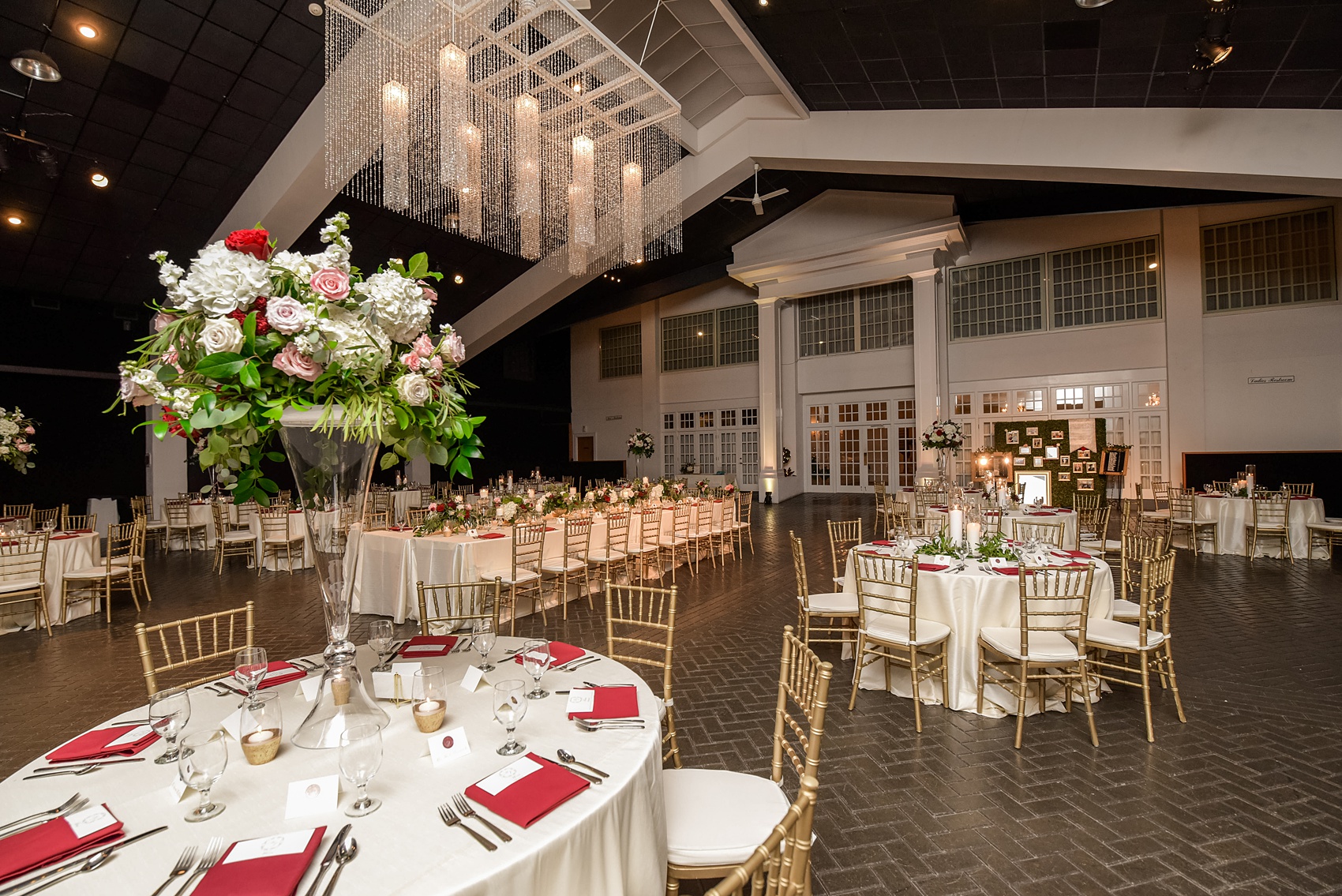 A fall wedding with burgundy, dusty rose and grey details. The reception room was filled with high + low floral centerpieces, with red and pink details, + lots of candlelight. Marble tiles served as table numbers. Mikkel Paige Photography, photographer in Greenville NC and Raleigh, captured this wedding at Rock Springs Center, planned by @vivalevent. Click through for more details and pictures from their day! #mikkelpaige #northcarolinawedding #southernwedding #weddingreception #burgundywedding