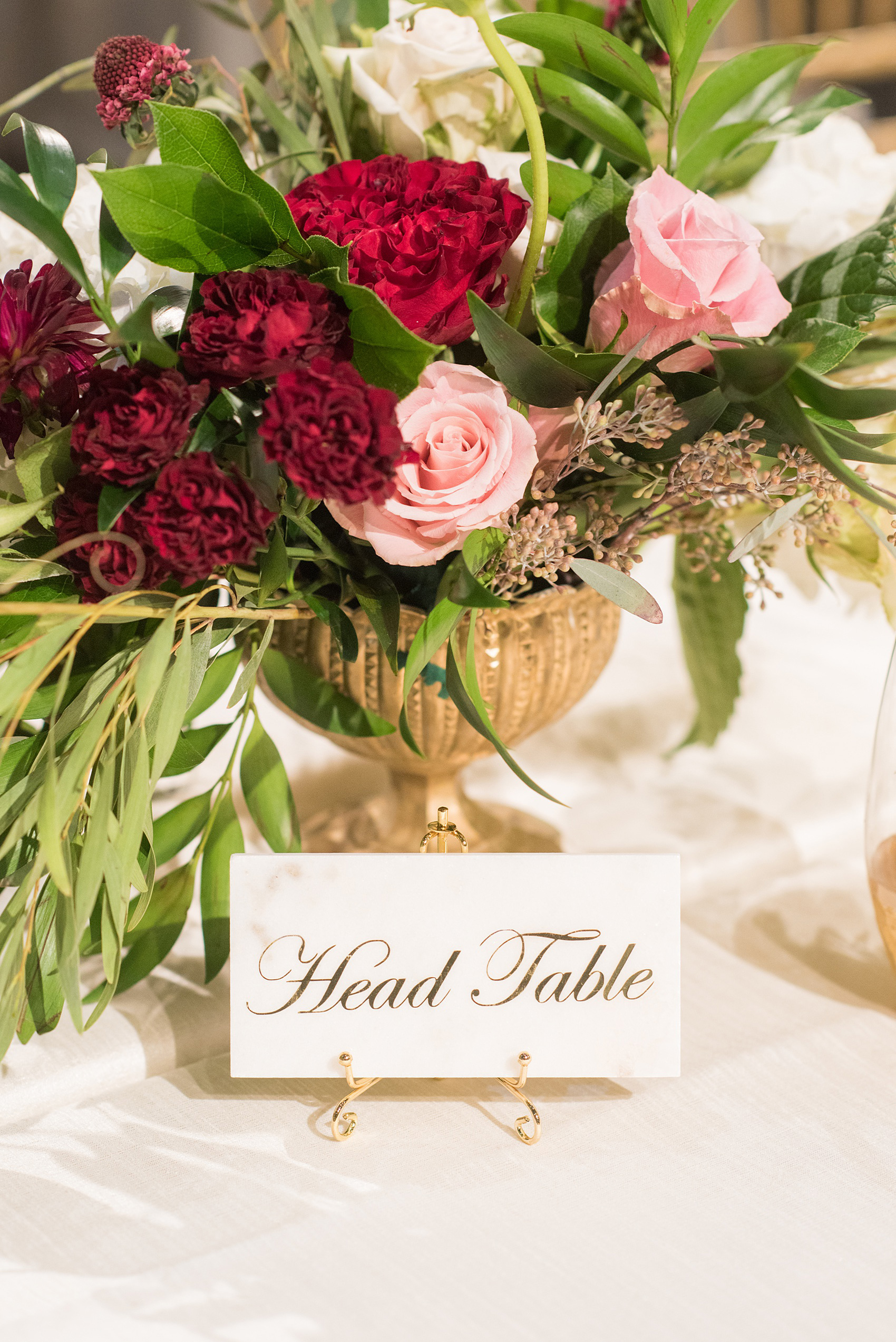 A fall wedding with burgundy, dusty rose and grey details. Mikkel Paige Photography, photographer in Greenville NC and Raleigh, captured this wedding at Rock Springs Center, planned by @vivalevent. The tables had marble tiles that showed table numbers in gold script. Click through for more details and pictures from their day! #mikkelpaige NCwedding #northcarolinawedding #southernwedding #tablenumbers