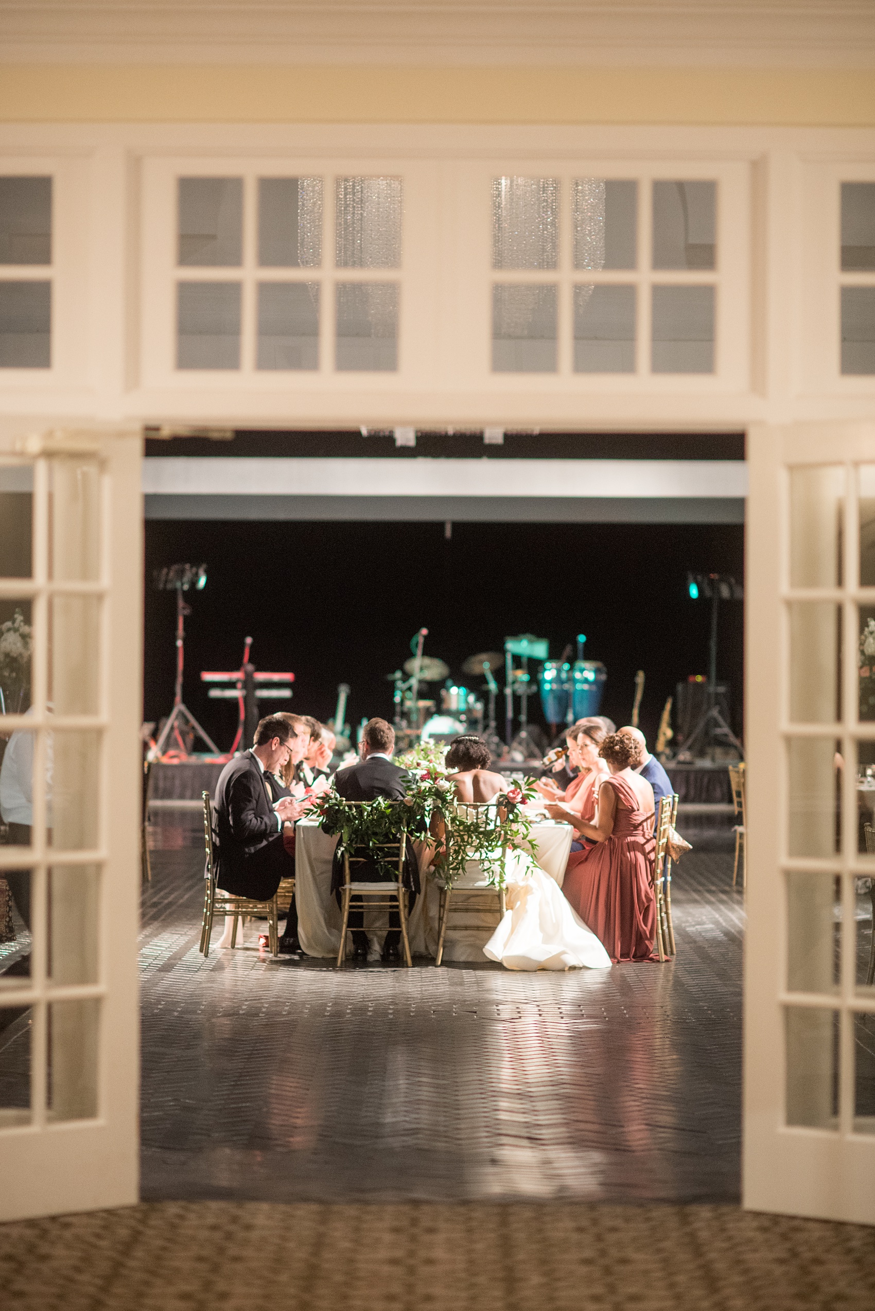 A fall wedding with burgundy, dusty rose and grey details. The guests partied on a black dance floor with a live band throughout the autumn celebration! Mikkel Paige Photography, photographer in Greenville NC and Raleigh, captured this wedding at Rock Springs Center, planned by @vivalevent. Click through for more details and pictures from their day! #mikkelpaige NCwedding #northcarolinawedding #southernwedding #weddingreception #burgundywedding