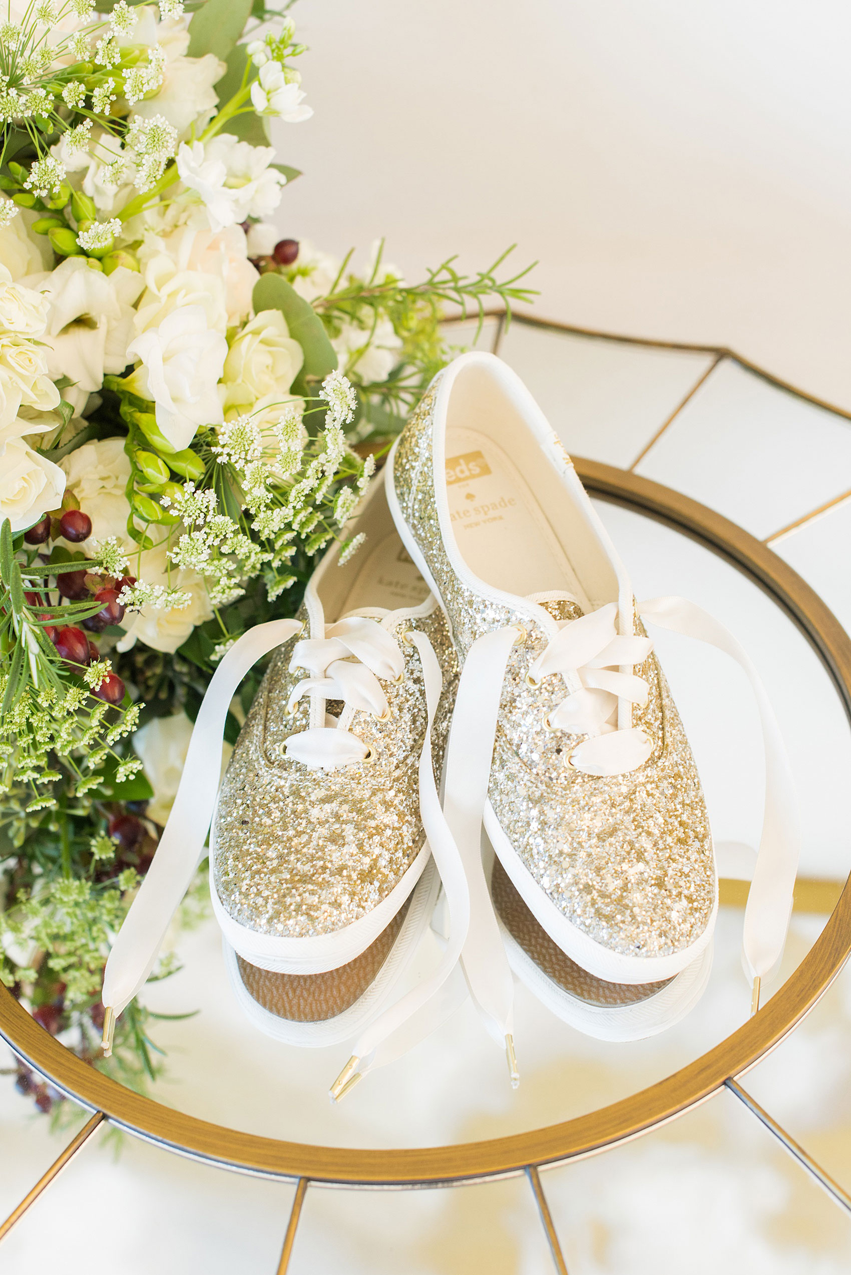 Pictures from a Christmas inspired wedding in downtown Raleigh, North Carolina by Mikkel Paige Photography. The bride had a simple style and chose to wear gold glitter Keds for her footwear. Click through for more from their beautiful celebration, including details and decor photos in a green and gold decor palette for their reception. #mikkelpaige #raleighweddingphotographer #downtownRaleigh #christmaswedding #greenandgoldwedding