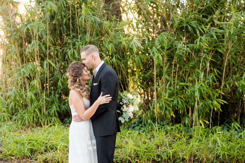 Pictures from a Christmas inspired wedding in downtown Raleigh, North Carolina by Mikkel Paige Photography. The bride and groom took outdoor portraits by their church. Click through for more ideas from their beautiful celebration, including details and decor photos in a green and gold decor palette for their reception. #mikkelpaige #raleighweddingphotographer #downtownRaleigh #christmaswedding #greenandgoldwedding #brideandgroom #bridal