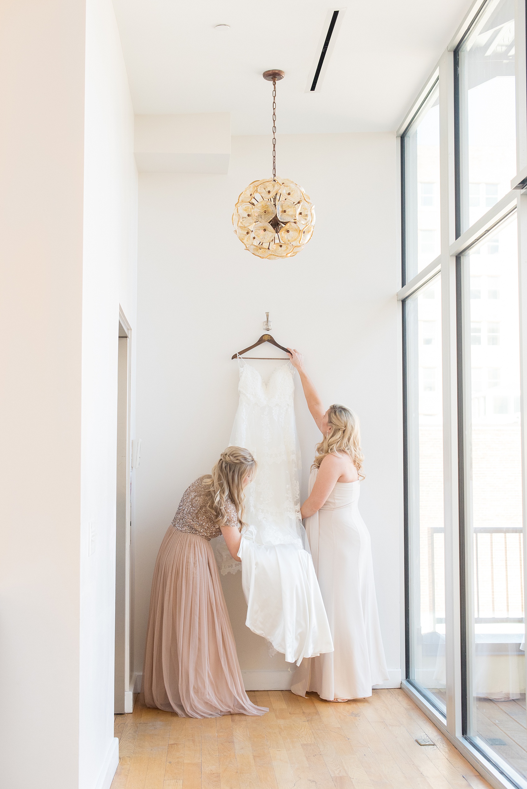 Pictures from a Christmas inspired wedding in downtown Raleigh, North Carolina by Mikkel Paige Photography. The bride and bridesmaids got ready for the church ceremony and reception at The Stockroom at 230, at The Glass Box. Click through for more ideas from their beautiful celebration, including decor photos in a green and gold decor palette. #mikkelpaige #raleighweddingphotographer #downtownRaleigh #greenandgoldwedding #gettingready #christmaswedding #bridesmaids #bridal