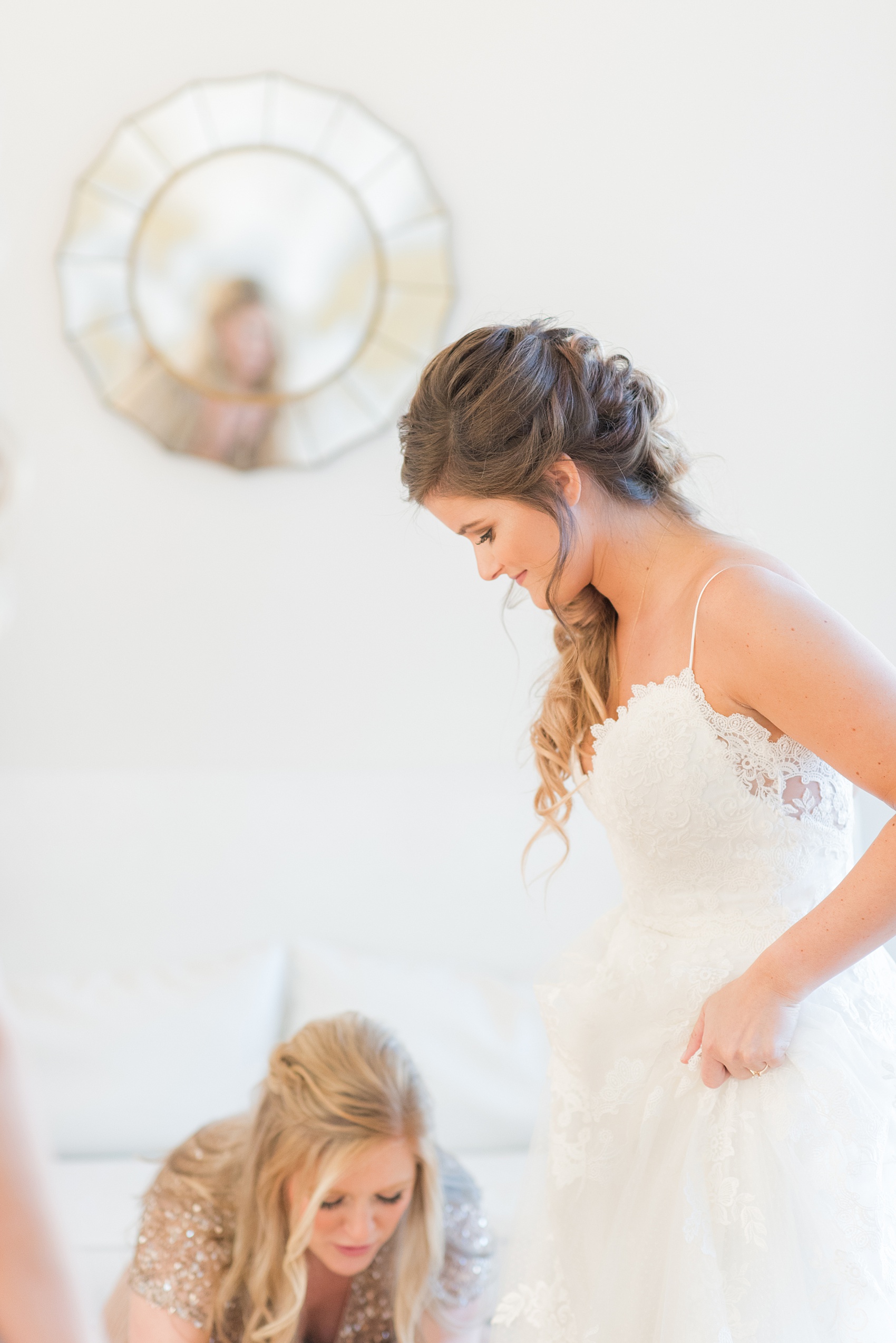 Pictures from a Christmas inspired wedding in downtown Raleigh, North Carolina by Mikkel Paige Photography. The bride and bridesmaids got ready for the church ceremony and reception at The Stockroom at 230, at The Glass Box in mismatched pink dresses. Click through for more ideas from a beautiful celebration, including decor photos in a green and gold decor palette. #mikkelpaige #raleighweddingphotographer #downtownRaleigh #greenandgoldwedding #gettingready #christmaswedding #bridesmaids #bridal