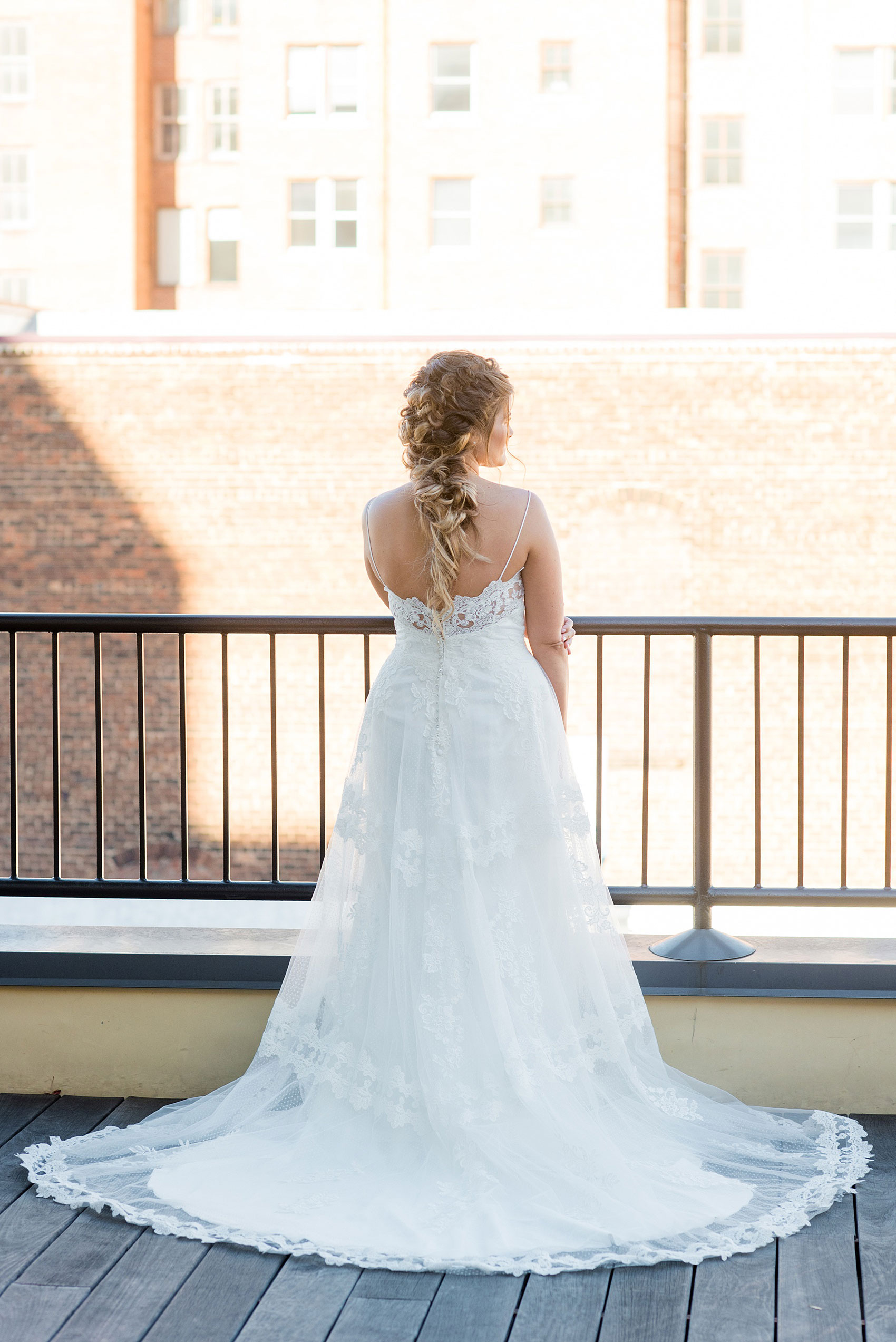 Pictures from a Christmas inspired wedding in downtown Raleigh, North Carolina by Mikkel Paige Photography. The bride took outdoor portraits by their church before their reception at The Stockroom at 230 and outdoors on The Glass Box. She wore a spaghetti strap gown and had a goddess braid hair style. Click through for more ideas from a beautiful celebration including details + decor photos. #mikkelpaige #raleighweddingphotographer #downtownRaleigh #greenandgoldwedding #bridestyle #goddesshair