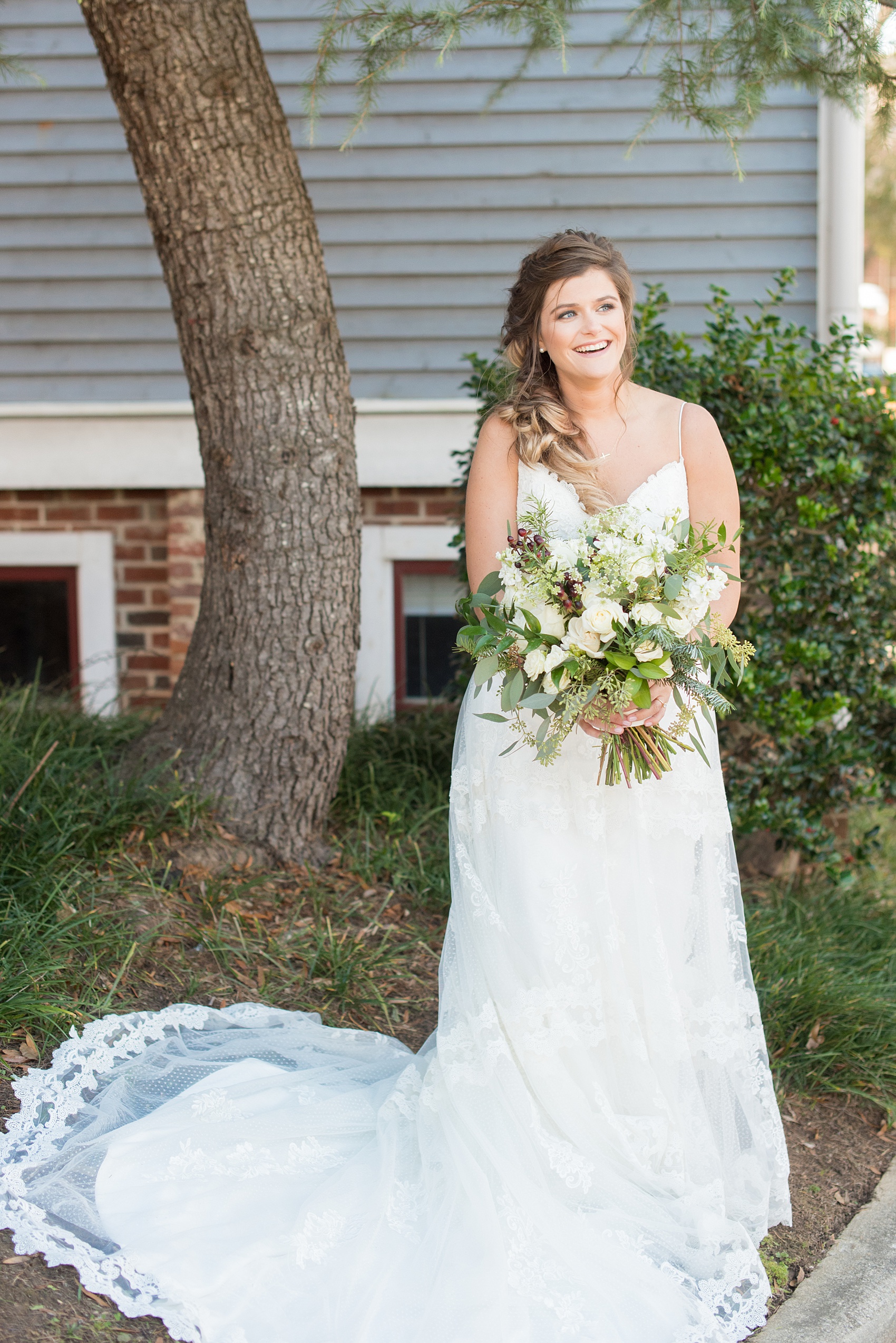 Pictures from a Christmas inspired wedding in downtown Raleigh, North Carolina by Mikkel Paige Photography. The bride took outdoor portraits by their church before their reception at The Stockroom at 230 and outdoors on The Glass Box. She wore a spaghetti strap gown and had a goddess braid hair style. Click through for more ideas from a beautiful celebration including details + decor photos. #mikkelpaige #raleighweddingphotographer #downtownRaleigh #greenandgoldwedding #bridestyle #goddesshair