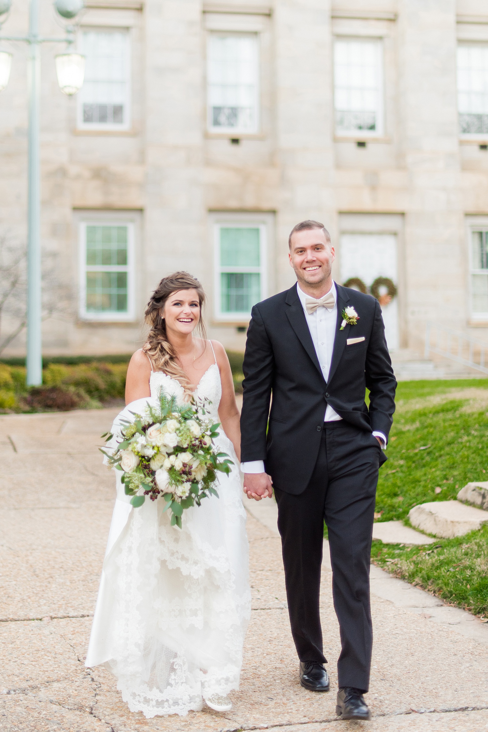 Pictures from a Christmas inspired wedding in downtown Raleigh, North Carolina by Mikkel Paige Photography. The bride and groom took outdoor portraits by their church. Click through for more ideas from their beautiful celebration, including details and decor photos in a green and gold decor palette for their reception. #mikkelpaige #raleighweddingphotographer #downtownRaleigh #christmaswedding #greenandgoldwedding #brideandgroom #bridal