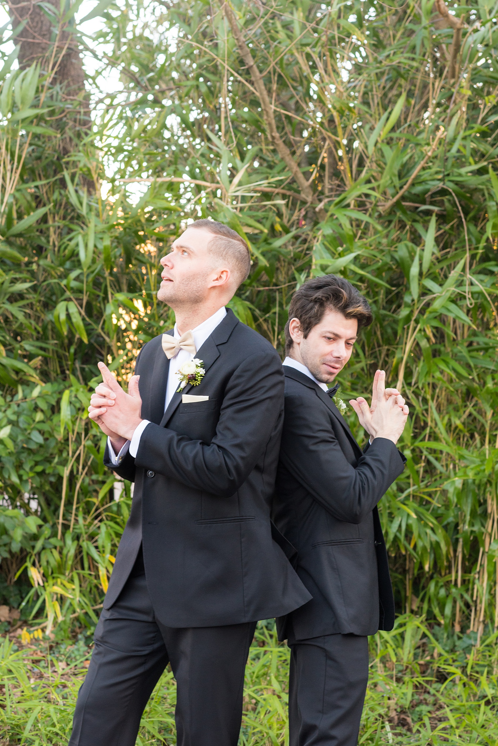 Pictures from a Christmas inspired wedding in downtown Raleigh, North Carolina by Mikkel Paige Photography. The groomsmen wore black tuxedos and wore holiday inspired boutonnieres. Click through for more outdoor and indoor ideas from this beautiful celebration, including decor photos in a green and gold decor palette for their reception at The Stockroom at 230. #mikkelpaige #raleighweddingphotographer #downtownRaleigh #weddingparty #holidaywedding #winterwedding #groomsmen