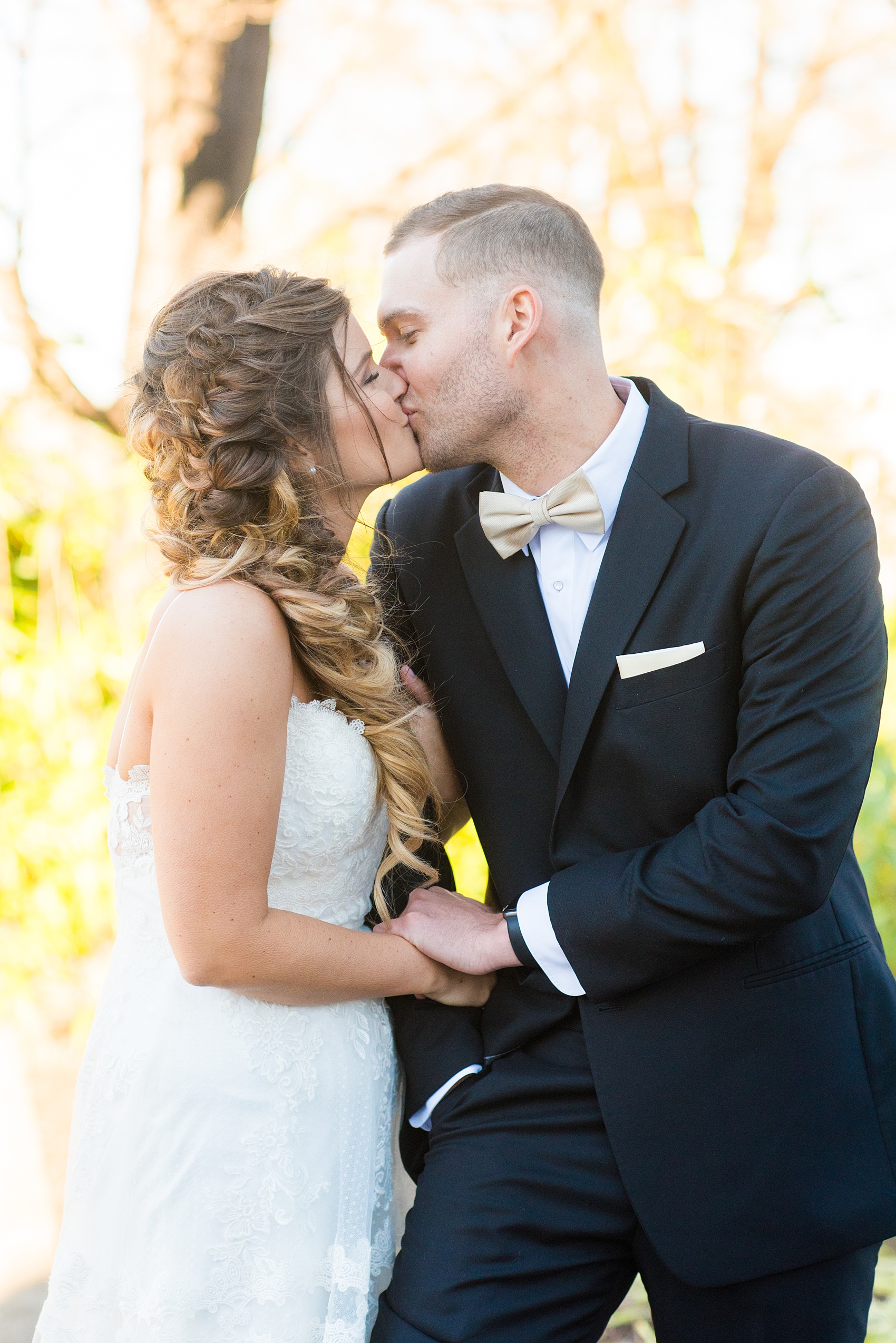 Pictures from a Christmas inspired wedding in downtown Raleigh, North Carolina by Mikkel Paige Photography. The bride and groom took outdoor portraits by their church and she had a beautiful goddess fishtail braid hair style. Click through for more ideas from their beautiful celebration, including details and decor photos in a green and gold decor palette for their reception. #mikkelpaige #raleighweddingphotographer #downtownRaleigh #christmaswedding #greenandgoldwedding #brideandgroom #bridal